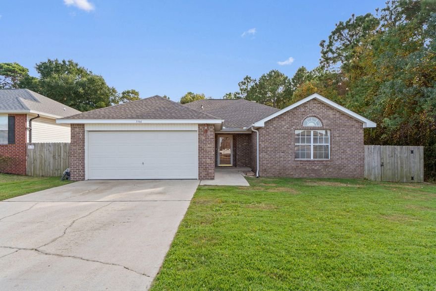 Located in a welcoming sidewalk neighborhood in Gulf Breeze, this 3-bedroom, 2-bath brick home offers comfort, privacy, and convenience all in one. The open layout features cathedral ceilings in the great room, creating a bright and airy feel that flows easily into the dining and kitchen areas -- perfect for everyday living and gathering with friends.

The spacious primary suite includes a tray ceiling, walk-in closet, double vanity, garden tub, and separate shower. Step outside to enjoy added privacy with wooded views behind the home and no neighbor to the right -- a rare find.

You'll appreciate the solid-surface flooring throughout -- no carpet anywhere -- offering a clean, low-maintenance environment with no staining concerns and fewer allergy triggers. The home is move-in ready as it sits, with the primary opportunity to personalize being a countertop change to stone or quartz in the kitchen and bathrooms -- that simple update would instantly upgrade the space.