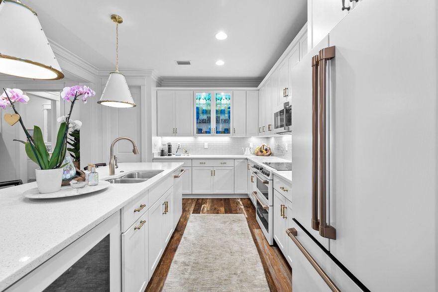 Positioned on a premium corner lot in the coveted Winter Garden phase of Watersound Origins, this beautifully appointed Huff-built home offers refined comfort surrounded by lush, mature landscaping. Designed for effortless single-level living, the 2,616-square-foot layout features four bedrooms, three and a half bathrooms, and a dedicated office or flex space.
Inside, the heart of the home centers around a thoughtfully designed kitchen featuring quartz countertops, custom cabinetry, and a new GE Café Series appliance suite — complete with induction cooktop, double ovens, wine and beverage fridge, dishwasher, and refrigerator. Updates continue throughout with stylish new lighting in the kitchen, dining area, and foyer. The open-concept design seamlessly flows into the living and dining spaces, while a screened porch equipped with Bromic heaters and fenced backyard provide inviting areas for outdoor relaxation and entertaining. The primary suite includes a custom California Closets upgrade, enhancing both organization and luxury. The home's location, just one block from the clubhouse, also provides easy access to a resort-style pool, playground, and fitness center.

Nature enthusiasts will appreciate the scenic trail located directly behind the home, offering both privacy and convenient access to the community's extensive pathways that connect to Watersound Commons. Residents enjoy an active, vibrant lifestyle with tennis and pickleball courts, a Davis Love-designed executive golf course, and year-round neighborhood gatherings. Nearby, the Monarch Art Trail and a growing array of shops, restaurants, and weekly farmers markets add to the community's appeal.

Set on a .19-acre corner lot within one of the most desirable non-short-term rental communities on the Emerald Coast, this home presents an exceptional opportunity to enjoy the best of Watersound Origins living, where natural beauty and modern convenience meet in perfect harmony.