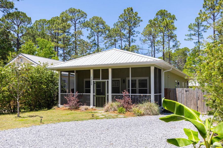 Custom built 3-bedroom Florida cottage with a metal roof, modern farmhouse charm and a prime lot ideally positioned across from the state forest. Located in the laid-back Magnolia Beach community with no HOA, this Point Washington home offers a peaceful setting close to Choctawhatchee Bay, while being just 4-5 miles from 30A, Grayton & Seagrove Beach. Attractive landscaping, board and batten siding, and a gravel driveway enhance the curb appeal, while the screened-in front porch creates the perfect spot for outdoor dining or morning coffee with tranquil forest views. Inside, the open-concept layout is filled with natural light and enhanced by ~15 foot vaulted ceilings, creating a bright and spacious feel throughout the home. Luxury vinyl flooring flows seamlessly from room to room, while thoughtful upgrades like non-toxic paint & water filtration add to the home's appeal. The kitchen blends style and function with a Quartz island, farmhouse sink, stainless appliances, custom backsplash, floating shelves, and elegant pendant lighting, all complemented by calming forest views. The spacious primary suite offers vaulted ceilings, direct access to the screened porch, a walk-in closet, and a beautifully designed ensuite bath featuring a double vanity, oversized shower, soaking tub & impressive wet room with subway tile extending to the ceiling. Enjoy an additional 436 square ft. of screened porch space between the front & back porches, creating multiple areas to relax or entertain. The fully fenced backyard offers space to play, entertain, or garden with planter boxes, mature landscaping, fragrant honeysuckle, and a storage shed for added convenience. Enjoy close proximity to Choctawhatchee Bay, the neighborhood park at the end of N 283, and Grayton Dunes Beach Access with its scenic boardwalk, showers, tram service, boat launch, and access to Western Lake, one of South Walton's rare coastal dune lakes. Popular local spots including Chiringo and the iconic Red Bar are also nearby, making this an ideal opportunity to enjoy the relaxed coastal lifestyle of Point Washington and 30A.