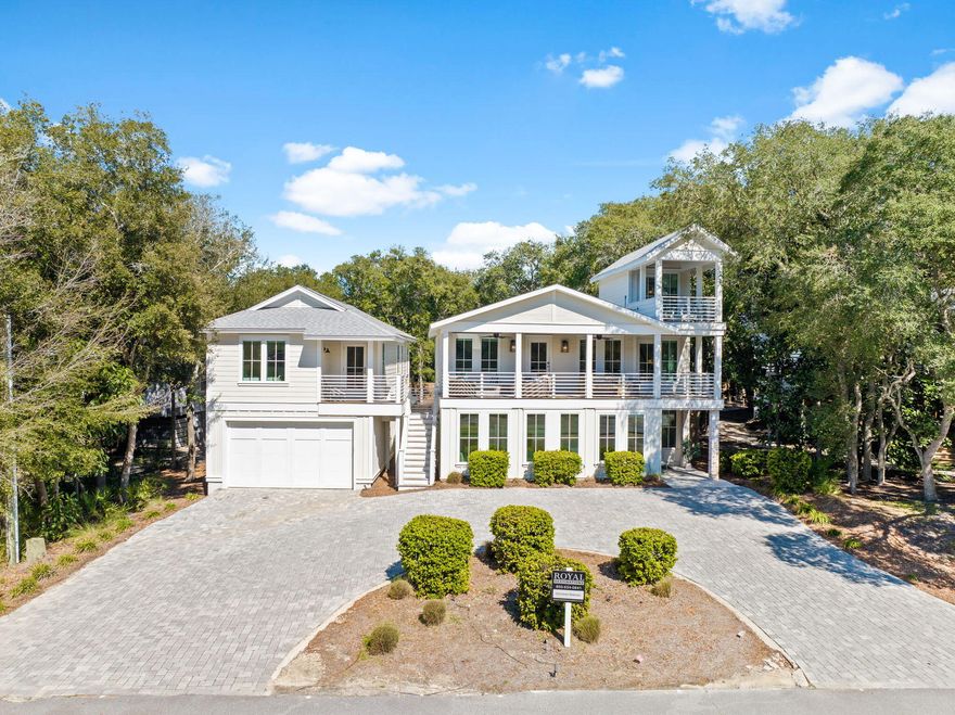 This freshly reimagined coastal escape delivers elevated 30A living without cutting a single corner. The property features a heated resort-style pool and a newly built oversized garage topped with an adorable carriage house that absolutely pulls its own weight.

Just a quick stroll from the sugar-white sand and emerald Gulf waters, the main home offers seven bedrooms and seven bathrooms and comfortably sleeps up to 22 guests. Translation: room for everyone and then some. Inside, the open-concept living space was designed to impress without trying too hard. A chef's kitchen anchors the home with stainless appliances, a generous island, and exposed brick details that flow effortlessly into the dining and living areas. Rich wood floors, custom trim, shiplap accents, marble tile, and designer finishes deliver that polished coastal look buyers crave.

Indoor and outdoor living blend seamlessly here. Spend mornings on the porch, afternoons poolside, and evenings enjoying the lush backyard oasis. The carriage house adds even more flexibility with a full kitchen, living space, bedroom, bathroom, and a covered patio overlooking the pool. Ideal for guests, in-laws, or anyone who believes vacation days should last forever.

And the location. This is where it really shines. You're close to Gulf Place for shopping, coffee, live music, and easy dinner plans plus beach access is within a five-minute walk at Beach Highlands, with Bullard Beach access nearby and a scenic stroll down to Dune Allen Beach access when you feel like mixing it up. Stinky's Fish Camp is close for sunset dinners, and a run to 3 Sons BBQ is practically a local rite of passage. Beach walks, fresh seafood, and laid-back coastal living are all right outside your door. This one checks every box and then casually adds a few more.