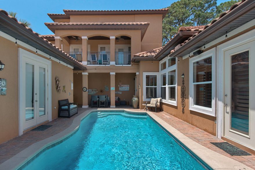 PRIVACY close to the beach!  GOLF CART friendly less than 1 mile from the WHITE SAND!  Perfect primary residence, second home or VACATION RENTAL / INVESTMENT opportunity!  Destiny East is a secure, private, GATED COMMUNITY. Private and community pools, easy access to the beach, large clubhouse area, tennis and basketball courts, fitness center, theater room, playground, lake access, and outdoor grilling areas. Only a few minutes away from Destin Commons & Gulf-front restaurants.  Situated on a LARGE LOT backing up to a nature preserve and positioned at the end of a cul-de-sac with minimal traffic.  Chef's kitchen, open concept, courtyard POOL and built in BBQ area with a separate GUEST HOUSE.  Private Entrance to Master Suite.  First level designated office space and a large laundry room. Second level boasts extra outdoor living space with multiple covered balconies from the bedrooms.  Home features a third floor space perfect for a media room, library, home gym, or craft space.  Amazing views.  One of the most beautiful Mediterranean homes Destiny East has to offer!  Two car garage with GOLF CART included.
