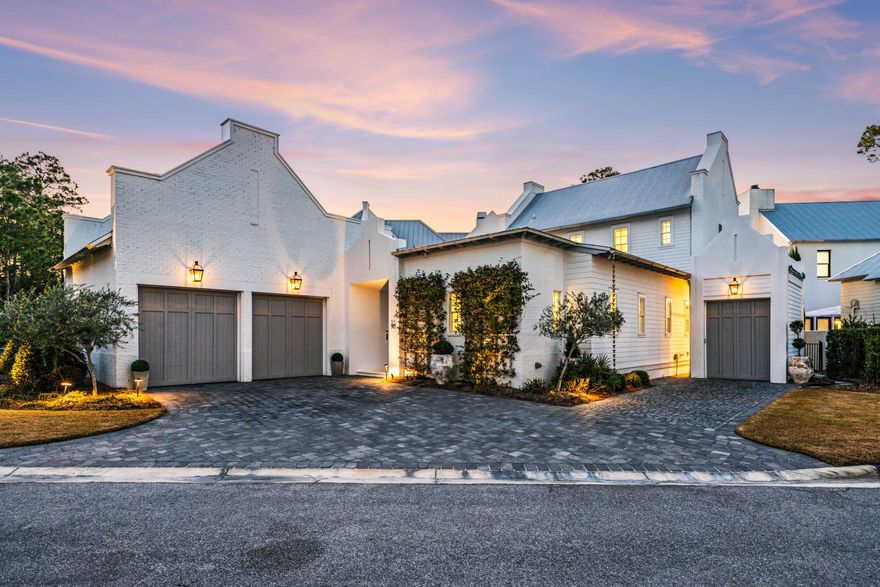 Set within the exclusive waterfront neighborhood of Churchill Oaks, 90 Perrin presents a masterfully designed coastal residence defined by sophistication and scale. Offering 2,988 square feet of heated and cooled living space and 4,385 square feet under roof, this two-story retreat is framed by gracious porches, a fully equipped summer kitchen, and multiple garage bays for seamless indoor-outdoor living.

At the heart of the home, a chef's kitchen showcases a professional-grade Wolf range, premium Liebherr appliances, quartz surfaces, and abundant custom cabinetry flowing effortlessly into a dramatic great room with 12-foot ceilings and an elegant fireplace centerpiece.

The primary suite is a serene sanctuary featuring a generous walk-in wardrobe and a spa-caliber bath designed for relaxation. A private courtyard offers a tranquil backdrop for intimate gatherings, while the air-conditioned two-car garage and dedicated golf cart garage provide both comfort and practicality. A whole-house generator and advanced water filtration system further elevate the home's standard of luxury living.