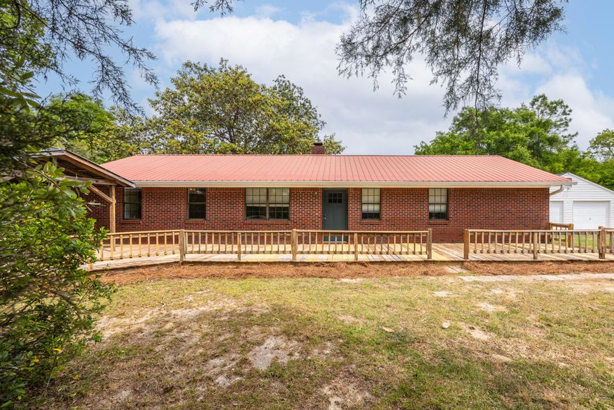 Welcome to your own slice of peaceful country living--just minutes from the conveniences of DeFuniak Springs! This charming single story, brick,  3-bedroom, 2-bath home offers the perfect blend of comfort, functionality, & serene surroundings, all nestled on a fully fenced 1.14-acre property. With NO HOA & Flood zone X, this property offers the freedom & flexibility for you to be creative. 

Step inside to discover a warm & inviting interior featuring brand-new vinyl plank flooring throughout, beautiful new master-bath shower upgrades, & cozy wood-burning fireplace with blower that anchors the living room. The spacious galley-style kitchen is a true highlight, showcasing beautifully updated granite countertops, freshly painted cabinetry, & ample storage and prep space. Just beyond, a large utility room--complete with washer/dryer hookups--adds even more convenience to everyday living

Outdoors, the property truly shines!!!
Mature landscaping creates picturesque setting, with thriving blueberry bushes, grapevines, crepe myrtles, azaleas, and stately oaks adding both beauty and charm. Whether you're hosting gatherings or enjoying a quiet morning, the covered gazebo/porch along with front and back decks provide ideal spaces for relaxing and entertaining. 

You'll appreciate the detached 2-car garage/workshop, offering plenty of space for projects, storage, or hobbies. If you're seeking a private retreat or envisioning your own hobby farm with a country feel--yet still close to town--this beautiful property truly delivers the best of both worlds. 

Plus, If you love the water or fishing, enjoy just around the corner  access to Juniper Lake, complete with a public boat launch and picnic area for outdoor recreation. Come experience the space, tranquility, and lifestyle you've been looking for! This also offers:
*Close proximity to world famous white-sand beaches of the Emerald Coast & 30A
*South Walton's renowned dining and shopping
*Destin's lively entertainment scene
*Eglin and Hurlburt Air Force Bases, major airports, and top-rated schools

Your Next Chapter Begins Here
This isn't just a home --it's the backdrop for a lifetime of memories.