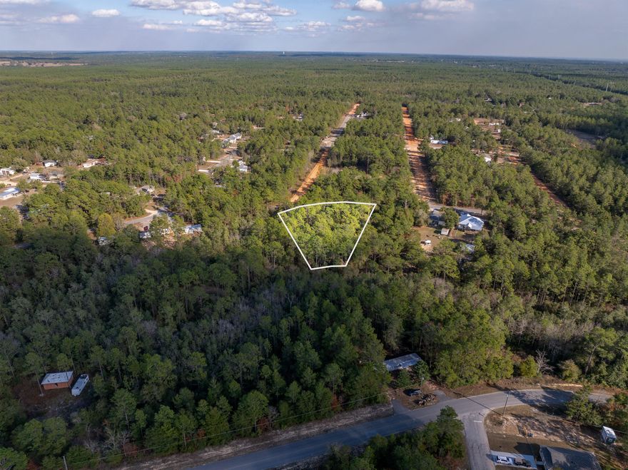 Discover the perfect opportunity to build in beautiful DeFuniak Springs! This serene 1.03-acre wooded triple lot offers endless potential—whether you're looking to build, place a new tiny home, or invest and hold longterm.
With no HOA, you have the freedom to create exactly what you envision: a dream home, a workshop, a mini farm retreat, or even develop three separate properties, one on each lot. Enjoy the privacy and beauty of nature!
Power and community water are available at the street (water & electric tap fees not paid). Lot dimensions are approximate—buyer to verify all boundaries, utilities, & intended use.  Come walk the property and explore its potential firsthand. Paved road. No flood insurance required.