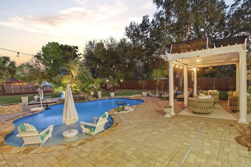 Welcome to this stunning and impeccably upgraded Navarre home. Combining luxury and efficiency with a fully paid-off ground-mounted solar panel system. The interior transitions seamlessly from the formal dining room and the elegant study - enclosed by custom glass French doors - to the main living areas featuring durable wood-look tile and sophisticated plantation shutters. The heart of the home is a chef's dream of a kitchen - showcasing gorgeous crème colored cabinetry with under and above cabinet accent lighting, high-end Samsung appliances, granite countertops, breakfast bar, and a stunning custom-built coffee bar with granite countertops and glass cabinetry. Decorative touches like a shiplap feature wall, new designer chandeliers throughout the home, and a custom-shelved pantry with a glass door elevate the aesthetic. The primary suite serves as a true sanctuary, featuring a tray ceiling with wood beam details, enhanced recessed lighting, custom-built walk-in closet systems, and a spa-like ensuite bathroom with double vanity, walk-in shower, upgraded mirror and light fixtures, water closet with bidet toilet, and a soaking tub. All four bedrooms offer a premium feel with high-end plush carpet and upgraded padding. The guest bathrooms have been fully remodeled - one to include a fully tiled walk-in shower, the other with a jetted tub with heavy glass doors and tiled walls. Practicality meets style in the laundry room with its custom wood shelving and the garage, which features professional floor coating, upgraded lighting, and overhead storage racks. The backyard is an absolute private oasis designed for world-class entertaining. A magnificent 32-foot saltwater pool with a custom rock waterfall and paver fire pit serves as the centerpiece, surrounded by lush Zoysia grass, palm trees, and decorative curbing. Outdoor dining reaches new heights under a 12-foot pergola housing a full kitchen equipped with KitchenAid and Blackstone grills, an ice maker, and a beverage fridge. For year-round comfort, the back lanai has been enclosed to provide an approximate 200 additional square feet of climate-controlled space, supported by both the main HVAC and a solar-powered mini-split. Additional upgrades include stamped concrete flooring on the front porch and lanai, a second large pergola, a storage shed, and a full gutter system. On top of all of this, you get to enjoy all of the amenities that Holley By The Sea has to offer - including a boat ramp, 8 clay tennis courts, a community event hall, 3 different pools, exercise room, and more!