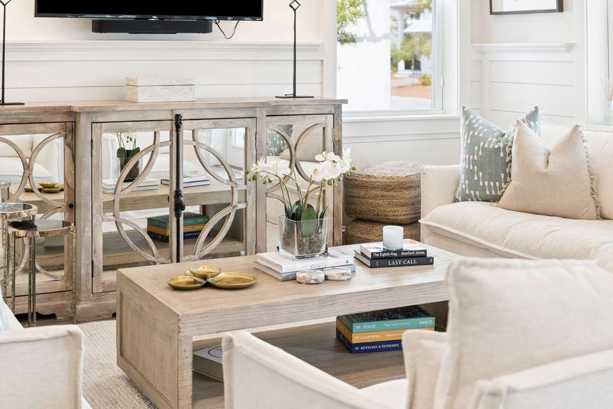 Meticulously maintained and beautifully appointed, this coastal retreat backs to a permanent green buffer, offering added privacy and serene views along the edge of the Watersound Beach community. A deep, welcoming front porch sets the tone, while three spacious porches totaling nearly 1,000 square feet create the perfect setting for enjoying the outdoor lifestyle.

Inside, the light filled open floor plan features a comfortable living area with shiplap accents and a dining space that comfortably accommodates six. Engineered hardwood flooring runs throughout, highlighting the home's quality craftsmanship. The kitchen is thoughtfully designed with ample counter space, maple cabinetry, built in stainless steel appliances, and a five burner gas range with a vented hood. A peninsula with bar seating provides a great spot for casual dining or entertaining.

The first floor primary suite offers a peaceful retreat with a spa like ensuite bath featuring dual vanities, a rain head shower, and a walk in closet. Just off the main living area, a screened porch overlooks the fenced backyard and grilling area, perfect for relaxing or hosting guests. A half bath, laundry room, and additional storage complete the main level.

Upstairs, a spacious king suite includes a private bath and large walk in closet. Two additional guest bedrooms share a well appointed bathroom and both open directly to the expansive second floor porch, ideal for morning coffee or unwinding on the swing.

Additional features include a one car garage with overhead storage and space for bikes. While never rented, this home is ideally positioned for strong vacation rental potential. Located on the quieter south side of Prominence, it is just a short distance to The Big Chill for dining, shopping, and entertainment. Community amenities include two pools, a fitness center, and easy access to the area's renowned white sand beaches, making this an exceptional opportunity for a primary residence, second home, or investment property.