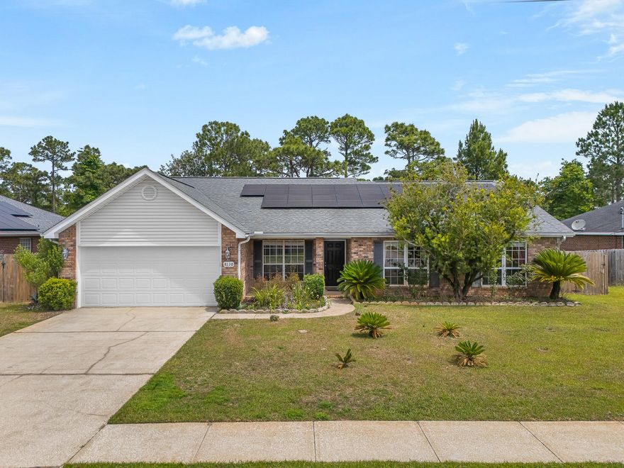 Tucked away in the heart of Navarre this home  is offering 4 bedrooms and 2 bathrooms situated on a .26 acre lot boasting a spectacular floor plan and solar panels to offset the rising costs of electricity! Featured is a generously sized living room with french doors leading to the fenced in back yard. There is a formal dining room that would make a great option for a home office just off the front entrance. Oversized kitchen has ample prep and storage with island, walk in pantry and breakfast nook area. The primary bedroom has two walk in closets and an en suite with walk in tub, double vanity, walk in shower and water closet. Three additional bedrooms share the second bathroom that has a large vanity with extra counter space. Dedicated laundry room and two car garage finish out this home