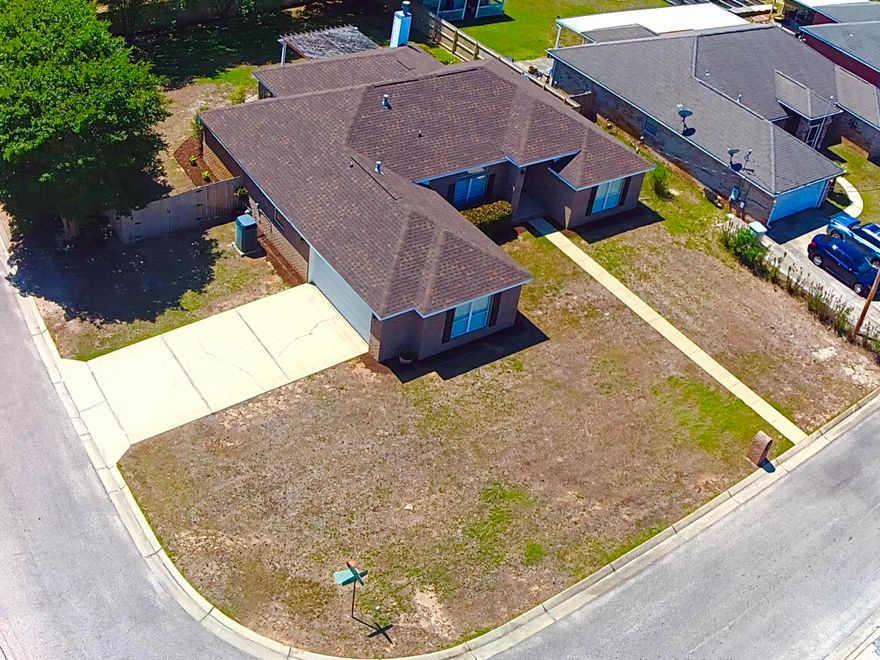 Welcome to this meticulously maintained all-brick, single-story home in the heart of Navarre! Offering 4 spacious bedrooms, 2 full baths, over 2400 sq ft of living space on a corner lot convenient to just about everything.
Step inside to an open floor plan designed for modern living, featuring durable and stylish Pergo flooring throughout the main living areas and primary. The home flows effortlessly from the living room into the dining and kitchen spaces, perfect for both everyday living and entertaining.  Enjoy the gas fireplace, kitchen with stainless steel appliances and ample storage and split bedroom floor plan. The primary suite is a true retreat, showcasing a fully updated bathroom featuring a stunning tiled shower with frameless glass, a jacuzzi tub, and quartz double vanities. Did we mention the his and hers walk in closets?  The 10' ceilings in the main living area, 8' x 8' patio door and generous windows throughout let in loads of natural light. Outside, enjoy your private fenced backyard complete with a charming pergola-covered patio, firepit area, mature trees and shed--ideal for outdoor dining, relaxing, or hosting gatherings. The oversized side-entry garage offers plenty of space for vehicles and storage. The corner lot makes accessing the single and double gates to the backyard a breeze. Located in a highly desirable area, this home is just minutes from town and within walking distance to the local high school and YMCA. Best of all--no HOA means more freedom and fewer restrictions.  You'll enjoy peace of mind with the new roof and gas water heater in 2024, a 4 ton Trane gas HVAC and hurricane rated garage door with fabric shields for all the windows.  This move-in-ready home checks all the boxes--don't miss your opportunity to make it yours!