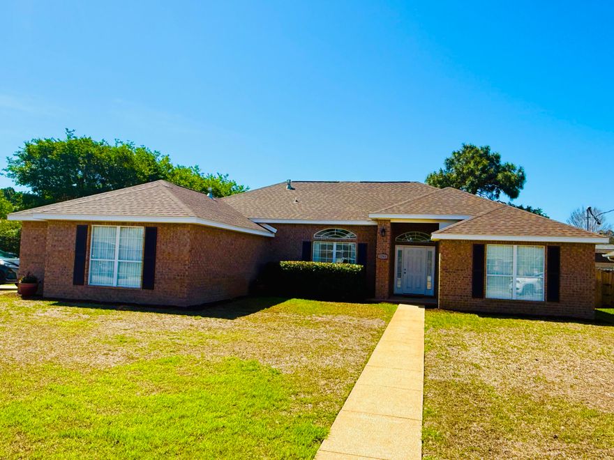 Welcome to this meticulously maintained all-brick, single-story home in the heart of Navarre! Offering 4 spacious bedrooms, 2 full baths, over 2400 sq ft of living space on a corner lot convenient to just about everything.
Step inside to an open floor plan designed for modern living, featuring durable and stylish Pergo flooring throughout the main living areas. The home flows effortlessly from the living room into the dining and kitchen spaces, perfect for both everyday living and entertaining.  Enjoy the gas fireplace, kitchen with stainless steel appliances and ample storage and split bedroom floor plan. The primary suite is a true retreat, showcasing a fully updated bathroom with a stunning tiled shower and frameless glass enclosure, a jacuzzi tub, and elegant quartz double vanities. Outside, enjoy your private fenced backyard complete with a charming pergola-covered patio, firepit area, mature trees and shed--ideal for outdoor dining, relaxing, or hosting gatherings. The oversized side-entry garage offers plenty of space for vehicles and storage. The corner lot makes accessing the single and double gates to the backyard a breeze. Located in a highly desirable area, this home is just minutes from town and within walking distance to the local high school and YMCA. Best of all--no HOA means more freedom and fewer restrictions.  You'll enjoy peace of mind with the new roof and water heater in 2024, a 4 ton Trane gas HVAC and hurricane rated garage door with fabric shields for all the windows.  This move-in-ready home checks all the boxes--don't miss your opportunity to make it yours! Professional photos coming soon!