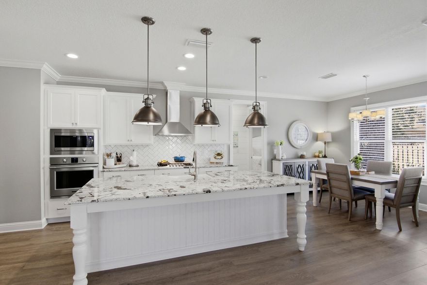 Welcome to this beautifully maintained home in the highly sought-after Hammock Bay community, where thoughtful upgrades and quality craftsmanship shine throughout. Now priced $35,000 below recently appraised value. Painted in a soft, light gray palette, the interior offers a timeless backdrop ready to complement any style. Step inside to find durable and stylish LVP flooring flowing through the main living areas, with elegant porcelain tile in the bathrooms for easy upkeep. Crown molding adds a refined touch throughout, while subtle shiplap detail in a transition space brings warmth and character. Ceiling fans in the living room, all bedrooms, and the flex room provide year-round comfort. The open-concept living space is designed for both everyday living and effortless entertaining. The spacious living room connects seamlessly to a stunning kitchen featuring quartz countertops, stainless steel appliances, a custom backsplash, and an oversized island with generous seating and serving space; truly the heart of the home. This thoughtfully designed floor plan offers three large bedrooms plus a versatile flex room, making it ideal for a fourth bedroom, guest space, or home office. The bathrooms echo the kitchen's upscale finishes with matching quartz surfaces for a cohesive, elevated feel. A spacious laundry room conveniently connects to the finished two-car garage. Situated on a desirable corner lot, the home's curb appeal immediately stands out.  A custom-designed paver patio creates a seamless transition from the front entry to the backyard, gently winding through lush garden beds and offering a charming outdoor passageway from the covered front porch around to the screened in back patio. Rain gutters surround the home, and the beautifully landscaped yard is complemented by a fully fenced backyard, providing privacy for relaxing evenings or hosting friends and family. Built by Randy Wise and spotlessly maintained, this move-in-ready home blends comfort, style, and exceptional outdoor living; all in one of Hammock Bay's most charming neighborhoods. Consider this your official invitation to experience what the Hammock Bay lifestyle is all about and schedule your showing today!