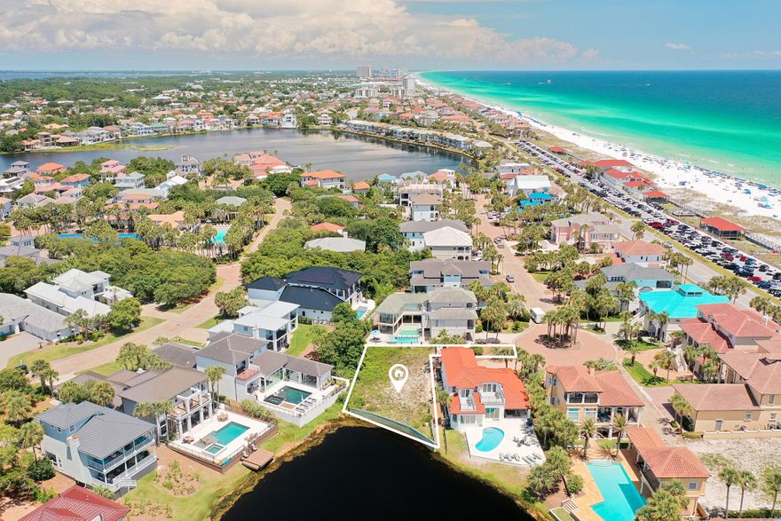 A western facing, lakefront building site awaits- one of the last available lots inside the gated community of Destiny! Prominently located near the Gulf of America, this lot has the ability to achieve both lake and gulf views.  Featuring a seawall and offering an impressive building footprint, this is the perfect opportunity for you to create a custom home or use the plans readily available from the Seller. Destiny subdivision is a private, gated community developed with the southern charm of brick paver streets and street lighting with world class resort amenities and exceptional short-term rental potential. The community maintains a clubhouse with an oversized pool and spa, workout center, tennis courts and is adjacent to a large beach access. The community and area is golf cart friendly and is centrally located to local shops and restaurants along Scenic Highway 98.