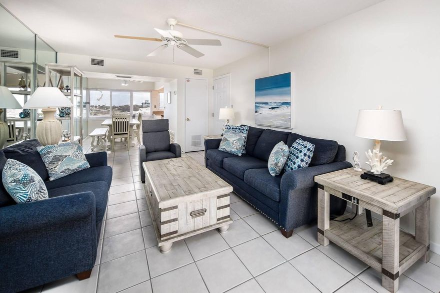 A beautifully updated coastal-inspired living 2-bedroom and 2-bathroom condo offers GULF-SIDE VIEWS with a perfect blend of comfort and relaxation. This newly updated condo features NEW FURNITURE through the living space, creating a fresh and modern atmosphere. The kitchen has been tastefully updated with NEW STAINLESS STEEL APPLIANCES, with generous counter space, flowing directly into the dining area, perfect for family gatherings. Both the primary bedroom and guest bedroom overlook BEAUTIFUL GULF SIDE BEACHES, offering both ample space and coastal scenery. The primary bedroom also features stunning parquet flooring, while the primary bath provides beautiful, neutral ceramic tile flooring. Stepping out onto your balcony, you will overlook the resort-style amenities that Seaspray Condos has to offer, which include a community pool, playground, fitness center, sauna/steam room laundry facilities, community/association room, and an on-site team.
