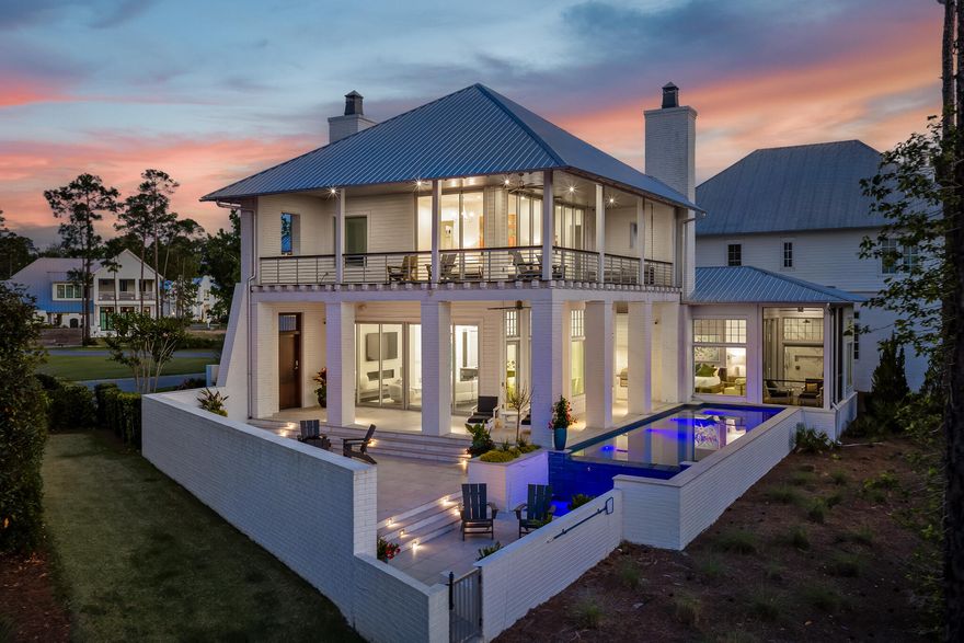 Located in the prestigious gated waterfront community of Churchill Oaks, this amazing contemporary home offers 4 bedrooms and 4.5 bathrooms plus a custom bunk room.  Positioned to capture the expansive bay views and backing to a conservation preserve, the property provides exceptional privacy.  Features include two primary suites, three laundry rooms, ceramic tile flooring, a walk-in climate controlled wine room and a steam shower.  The chef's kitchen is equipped with premium Miele appliances, custom cabinetry and designer lighting.  Outdoor living includes a negative edge pool and fire pit, ideal for enjoying the waterfront setting.  The property also includes a 50 FOOT BOAT SLIP making it ideal for boating enthusiasts. A beautifully designed carriage house above the garage, is complete with a private entrance for added flexibility and privacy.  Connected to the main residence by a charming breezeway, the space is ideal for guests and extended family. The carriage house features a mini kitchen, and it's own washer and dryer, creating a functional and comfortable separate living area.  Churchill Oaks includes an expansive bayfront clubhouse, marina and walking paths.