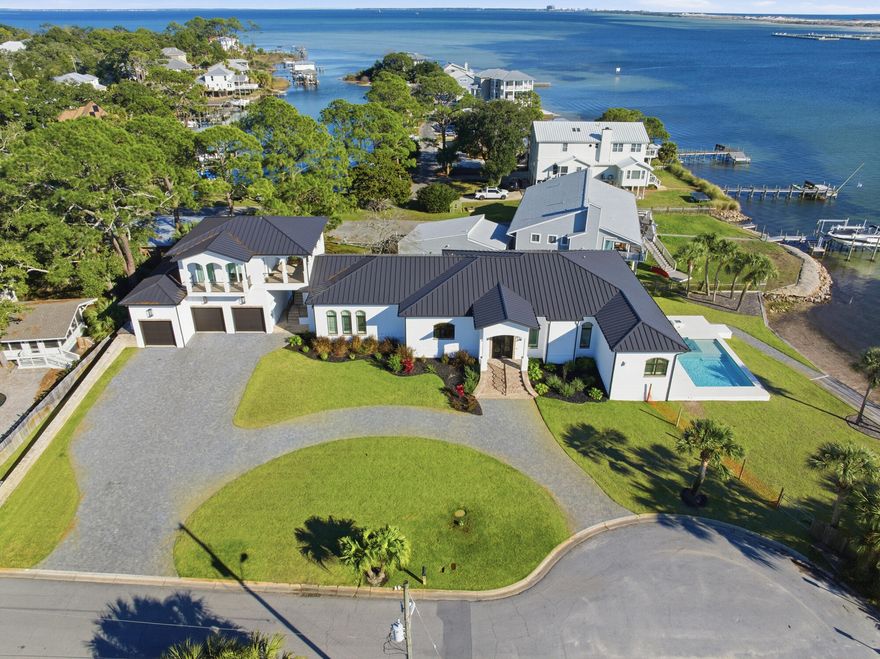 This is not simply a waterfront home -- it is one of the most significant private estates ever offered in Fort Walton Beach.
Positioned on an extraordinary .65-acre corner lot with 137 feet of pristine waterfront, spanning 7,900-square-foot coastal estate delivers a level of scale, privacy, and architectural presence that is rarely seen--and nearly impossible to replicate along the Emerald Coast.
From the moment you enter, panoramic water views command every space, creating a seamless connection between refined interior living and resort-style outdoor experiences.
The primary suite is a true retreat, featuring a private fireplace, automated shades that reveal the sunrise over the water, and a spa-caliber bathroom complete with an oversized soaking tub, expansive rain shower with dual glass entry, separate vanities, and custom his-and-hers walk-in closets--all anchored by statement designer finishes.

At the heart of the home, the chef's kitchen is both functional and striking, showcasing quartz surfaces, custom gold accents, and dramatic architectural beams, flowing effortlessly into multiple entertaining spaces, including a private bar lounge, wine storage, and an oversized pantry designed for elevated hosting.

A separate carriage house with its own private balcony overlooking the water provides exceptional flexibility for guests, multigenerational living, or a private executive retreat.

Outdoors, the property transforms into a private waterfront resort:
A heated saltwater pool and infinity-edge spa overlook the water, while expansive terraces, a firepit lounge, and outdoor media space create an unmatched setting for both intimate evenings and large-scale entertaining.

The marina-grade dock, complete with two private boat lifts, offers direct access to Crab Island and the Gulf, delivering the lifestyle that defines true coastal luxury.

Additional features include a fitness suite with sauna readiness, full smart-home automation, and a supercar- and RV-capable garage, ensuring the estate performs as seamlessly as it presents.

This property is not just rare--it represents a new benchmark for luxury in Fort Walton Beach.

For buyers who understand the value of waterfront frontage, acreage, privacy, and irreplaceable location, opportunities like this do not come twice.