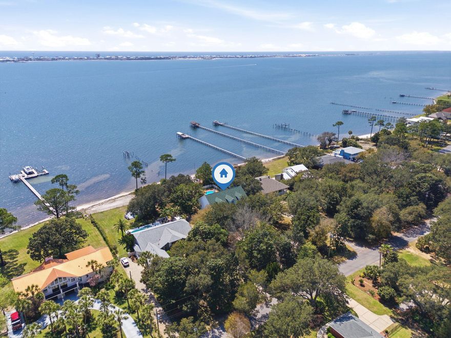 First time ever on the market -- a rare waterfront opportunity on Pompano!

Situated on an incredible 3/4 of an acre waterfront lot with its own white sandy beach, this property offers the kind of setting that is becoming nearly impossible to find. With breathtaking water views, an inground pool, and expansive outdoor living spaces, this home is ready for its next chapter.

The home features a newer roof and brand-new windows currently on order and scheduled for installation within the next two weeks, providing peace of mind for the future owner.

Inside, you'll find an abundance of natural light pouring through the home along with a kitchen that offers plenty of cabinet space for storage and functionality. Some areas feature hardwood flooring that could easily be refinished to bring back its original charm.
The main floor layout includes the primary bedroom, dining room, breakfast nook, living room, and laundry room, creating convenient everyday living. Downstairs, you'll find additional bedrooms along with another full bathroom that offers direct access to the pool area, making it ideal for entertaining or guests.

The oversized front porches create a welcoming entrance and provide the perfect place to relax and take in the peaceful waterfront setting.

For those needing space for vehicles, hobbies, or storage, the property includes a true oversized three-car side-entry garage, offering more room than a standard garage.

With no HOA, you'll enjoy the flexibility to bring your boat, camper, or recreational toys home with ease.
This property has incredible potential and is ready for your personal renovation and modern design vision. Whether you're looking to create your dream waterfront residence, a vacation getaway, or a potential Airbnb investment, the possibilities here are endless.

Aside from the upcoming window installation, the home will be sold as-is.
Private tours are welcome, and open house events will be announced soon.
Don't miss this rare opportunity to own a large waterfront property with sandy beach frontage on Pompano.