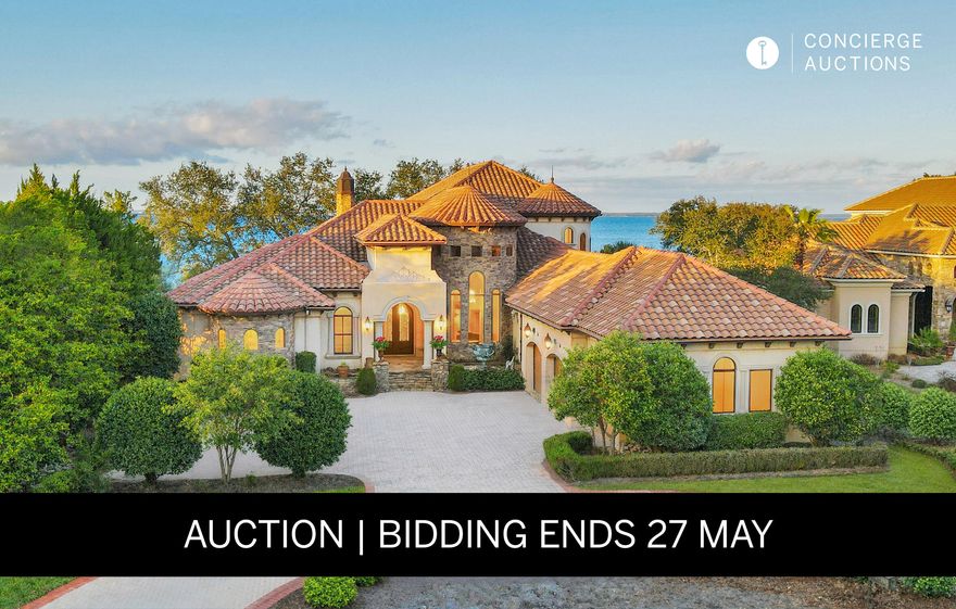 This American Dream home was featured on a national TV show called American dream homes, on the Discovery channel. This Home is considered to be a premier property in Regatta Bay, because it has lake views from the front and Panoramic Bay views from the back. Breathtaking sunsets await, for the future owners of this magnificent home. This executive estate offers easy golf cart access to the beach This ICF-constructed architectural beauty unites the distinctive details of a stately chateau-style home with modern, coastal themes for an awe-inspiring waterfront experience. Situated on 118 feet of desirable shoreline, this estate features an abundance of alfresco living including an almost 1200-sq-ft screened-in lanai with heated, saltwater pool, spa, summer kitchen, and outdoor fireplace.