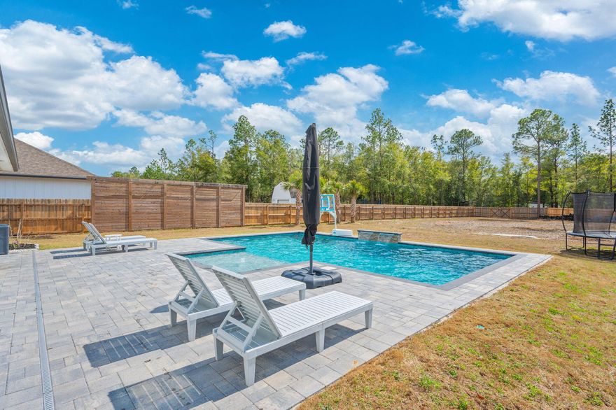 **SELLER TO CONTRIBUTE $5,000 TOWARDS BUYERS CLOSING COSTS!**GORGEOUS - stunning pool home on a 1/2 acre cleared lot in north Crestview, just 5 minutes from Publix, restaurants, and other area amenities. STACKED with updates and turn-key. Saltwater gunite pool has a pebblesheen (lifetime) finish and is 16'x30' and packed with upgrades and has a removable baby gate/fence. This 4 bedroom home features 3 FULL baths and raised ceilings throughout this open floor plan. Beautiful open kitchen overlooks the spacious main living area, and has a large dining area attached. Carpet ONLY in bedrooms with luxury vinyl throughout elsewhere. Fourth bedroom is split from the additional two bedrooms and master bedroom with the third bathroom right outside the room- perfect for guests, in laws, or a private office space. Matching granite countertops throughout kitchen and baths. Crown molding in main living space and master bedroom. Master bath houses double vanities, soaking tub, walk in shower, and custom master closet. Interior of home has also been recently freshly painted! This home was made for Florida living with all the updates to the exterior, providing both a functional and comfortable space for living and entertaining. Front porch, back porch, and THREE car garage all have epoxy floors. Roomy back porch is screened in and leads to your outdoor oasis. The gunite pool has a removable fence surround (easy removal and install!) and paver surround which also leads to an outdoor shower and pathway. The half acre lot has been completely cleared and allows plenty of opportunity for a workshop, shed, or additional outdoor usage. Additional notable exterior features include Govee LED light system, storm door, whole house gutter surround, and solar lights on the fence surround. ADT alarm system with all the add ons. Full upgrades list with additional details available. Schedule your showing today! VA assumable loan. More details available upon request.