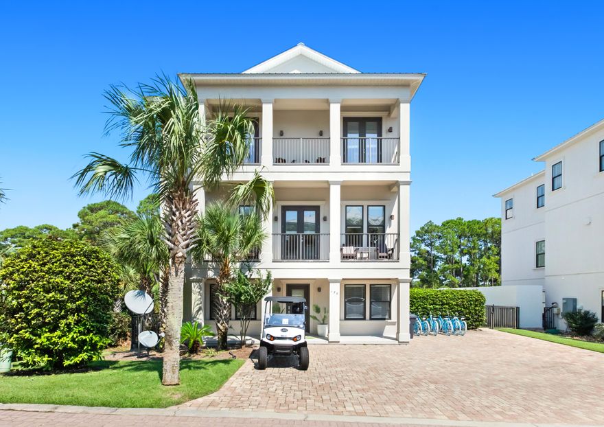 Embrace refined coastal living—and a premier investment opportunity—in this luxury residence on an oversized lot along the coveted west end of 30A. A stately columned façade, ample parking, and inviting porches set a timeless tone. This three-story home, accessible by private elevator, offers six spacious bedroom suites, including three on the main level. The second floor features an elegant open-concept living area with hardwood floors, formal dining, and a beautifully appointed kitchen. The third-floor master retreat boasts sweeping west-facing sunset views. Outdoors, enjoy a private pool, spa, tanning ledge, and wrap-around putting green. Just a short walk to Dune Allen Beach and minutes from Gulf Place, Grand Boulevard, and Santa Rosa Golf & Beach Club.
