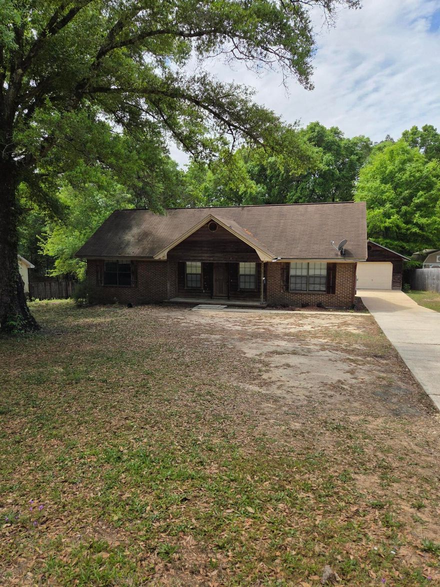 Country Living at its BEST. Rural and retro brick and cedar home with a detached garage. This home is set back from the road and offers a private rustic setting. It has a .large yard with shade trees, a small back deck and a covered front porch, The house offers the comfort of a split bedroom floor plan, a living room, a large kitchen with ample cabinets and a dining room.  The large laundry room has access to the deck and backyard. Easy for children to pop out to play and for access to the BBQ grill.  Don't be deceived by the square footage - this home lives larger. Bring a paint brush and some fresh ideas for your own color palette. Bob Sikes elementary School is a short distance away and many newer facilities are located in this northern Crestview area.  Enjoy mornings and evenings..... on the back deck or front porch.  You will be happy to be home. The new by-pass will open soon to allow a better commute to Eglin AFB 7th Special Forces and Hurlburt Field for military bases.