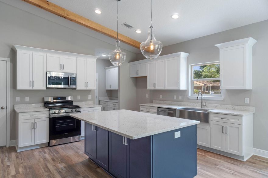 You'll notice the thoughtful architectural details that set this home apart from typical new construction the moment you arrive. A welcoming covered front porch creates the perfect introduction to this stunning semi-custom Craftsman-inspired home offering 1,607 square feet of beautifully designed living space with 3 bedrooms and 2 bathrooms. Inside, the main living area features soaring vaulted ceilings and striking custom cypress wood beams that create warmth, character, and an inviting sense of space throughout the home. The designer kitchen is the heart of the home, showcasing an oversized island, elegant quartz countertops, soft-close cabinetry and drawers, and a convenient butler's pantry that provides additional storage and prep space. Stainless steel appliances complete the kitchen, including a gas range--an upgrade rarely offered in most new construction homes where electric ranges are standard. The open-concept layout flows seamlessly into the spacious family room, making it ideal for everyday living and effortless entertaining. The oversized owner's suite is privately located on the main level, offering a relaxing retreat with a beautiful trey ceiling and recessed lighting that enhance the room's spacious feel. The spa-inspired owner's bathroom features a luxurious freestanding soaking tub and a beautifully tiled walk-in shower extending all the way to the ceiling. The secondary bedrooms are situated on the opposite side of the home, creating a desirable split-bedroom floor plan that provides additional privacy and functionality. Modern conveniences include a tankless gas water heater, ensuring energy efficiency and virtually endless hot water for everyday comfort. Covered back patio--perfect for enjoying morning coffee, hosting gatherings, or relaxing outdoors year-round. THESE ARE STOCK PHOTOS - NOT ACTUAL LOT-SPECIFIC FINISHES. PHOTOS ARE OF SIMILAR HOMES PREVIOUSLY BUILT. Estimated Completion time is the end of April, 2026.