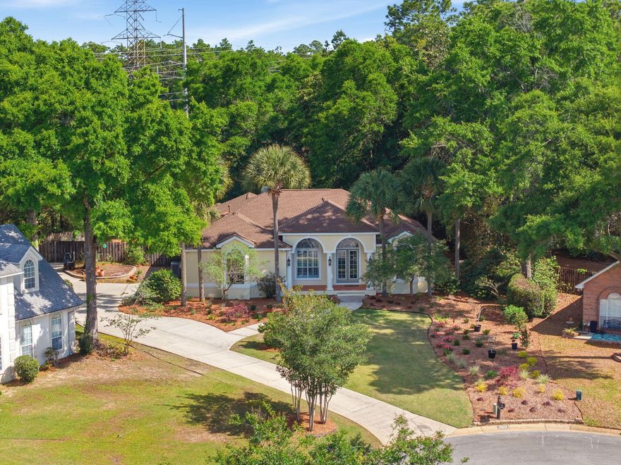 This is the one you've been waiting for! An exceptional executive home that perfectly blends luxury, privacy, and peace of mind. Welcome to this stunning residence in the highly sought-after upscale neighborhood of Scenic Hills North. This home truly stands out and will not last long. Built by Randy Lemon, this beautifully crafted South Florida-style home showcases exceptional quality and elegant architectural details, along with a thoughtfully designed open floor plan featuring soaring 10-11+ ft ceilings, 8 ft doors, archways, 18'' diamond-set tile, and a wood-burning fireplace with custom mantel and built-ins. The split-bedroom layout offers both privacy and functionality, with spacious secondary bedrooms and a well-appointed shared bath. The primary suite is a true retreat, featuring two large closets and a luxurious, updated bath complete with a reconfigured walk-in shower, garden tub, double vanity, heater, and designer tile finishes. The kitchen is a showstopper! Perfect for entertaining with updated appliances, a large breakfast bar, and seamless flow into the great room. Natural light fills the home through glass sliding doors, drawing your eye to the peaceful, private backyard that backs up to the University of West Florida nature preserve offering no rear neighbors and serene views year-round. Enjoy true indoor-outdoor living with a screened-in porch, ideal for relaxing or entertaining guests. Major upgrades provide peace of mind, including the roof, HVAC, tankless water heater, whole-house generator, and more. Perfectly situated high and dry on a quiet cul-de-sac with a side-entry garage and excellent curb appeal, this home checks every box. Homes like this rarely come available. Schedule your showing today before it's gone.