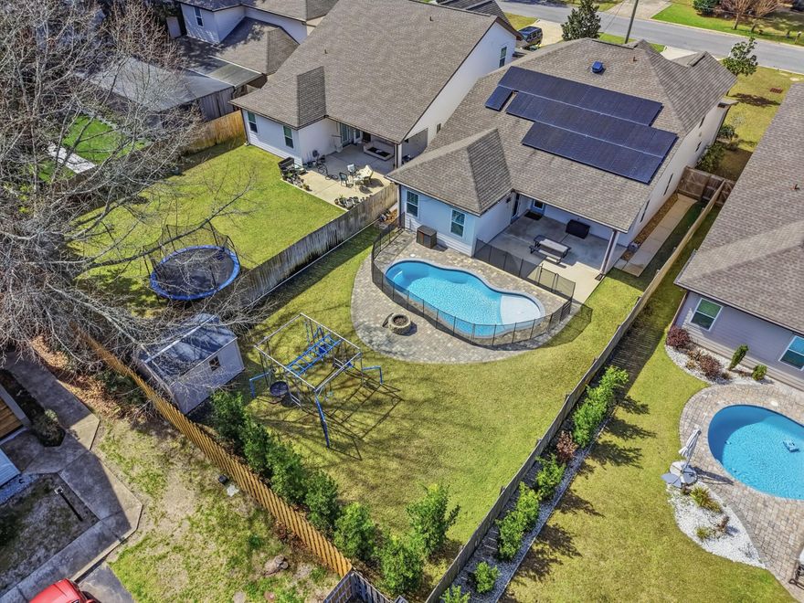 Beaches, boating, local dining, and weekend events--all just minutes from your door. Imagine mornings at the public boat launch, afternoons at the Member Only Ft Walton Yacht Club with its private beach and dining, and evenings unwinding in a neighborhood where golf carts are part of daily life. No HOA, no rental restrictions.

What makes this home truly unique is that it's not a spec build--it was designed specifically for this location. The main floor features the master suite, two additional bedrooms, and a guest bathroom along with the main living areas to include open floor plan and separate dining room. Floors are woodgrain tile throughout with carpet in bedrooms and upstairs. Upstairs, you'll find a fourth bedroom, a full bath, and an entire second living space, offering endless possibilities as a media room, home office, guest retreat, or creative space. 

Outside, your private backyard oasis awaits: a heated gunite pool, fenced yard for privacy, and a removable pool safety gate for peace of mind. Paid-off solar panels provide excellent electric efficiency and long-term savings, adding both value and sustainability.

This home blends modern design, flexible living, and coastal charm, perfectly positioned to enjoy the Emerald Coast lifestyle--whether as a primary residence, vacation escape, or investment opportunity.