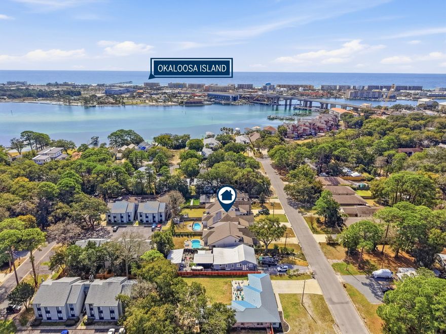 Built in 2018 and thoughtfully designed for both everyday comfort and entertaining, this spacious four-bedroom, three-bath residence sits in Elliot Pointe in the heart of downtown Fort Walton Beach, just moments from the water. Positioned in a golf cart-friendly area with convenient access to boating, beaches, dining, and local events, the home offers an exceptional blend of modern construction, flexible living space, and coastal lifestyle appeal. Inside, the two-story layout offers a bright and open atmosphere highlighted by 10-foot ceilings and quality finishes throughout. The main level features three bedrooms and two full bathrooms, including a private primary suite with a split floor plan that provides both comfort and privacy. Wood-grain tile flooring flows throughout the living  spaces while coffered ceilings, recessed lighting, plantation shutters, and fresh interior paint create a polished and inviting environment. The kitchen serves as the central gathering space with shaker-style cabinetry, soft-close doors and drawers, granite countertops, stainless steel appliances, and plenty of room for both cooking and conversation. A second living room upstairs adds valuable flexibility to the floor plan. This level also includes a fourth bedroom with two closets and a full bathroom, making it ideal for guests, a media room, a home office, or a private retreat for extended family. Outdoor living takes center stage in the private backyard, where a heated in-ground gunite pool creates a resort-style setting perfect for relaxing afternoons or weekend gatherings. The fenced yard provides added privacy while the removable pool safety gate offers peace of mind. Energy-efficient solar panels, already paid off, add long-term savings and sustainability. Location enhances the lifestyle even further. A public boat launch sits just a few blocks away, making spontaneous days on the water effortless. The nearby Fort Walton Yacht Club offers optional membership with dining, a private beach, event space, boat slips, a pool, and a vibrant calendar of activities just about a mile from the home. With no HOA and no rental restrictions, the property offers rare flexibility for homeowners and investors alike. The surrounding downtown area continues to evolve with redevelopment momentum and the highly anticipated Brooks Bridge project, expected to enhance connectivity and long-term property values. This is a modern coastal home positioned perfectly for enjoying the Emerald Coast lifestyle, whether as a primary residence, second home, or investment opportunity.
