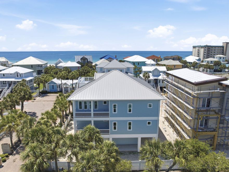 Newly completed in 2026, this stunning corner-lot beach home offers the rare opportunity to be the first to own & enjoy this beautifully crafted coastal residence in the serene Parasol community. Designed to embrace the beauty of Gulf Coast living, the home features multiple porches along with a spectacular top lookout deck showcasing breathtaking views of the Gulf & Intracoastal Waterway. From unforgettable sunsets to coastal breezes, every space was created to enhance a coastal lifestyle. Private elevator provides convenient access to each level. Each bedroom offers private exterior access. Main floor offers a spacious junior primary suite complete with an elegant en suite bath. Two additional large guest bedrooms are also located on this level along with a versatile lounge space featuring a wet bar sink & beverage cooler. Perfect as a media room, play area, office, game room, or additional entertaining area for guests, this flexible space adds incredible versatility to the layout. Top floor is dedicated to the main living spaces where soaring ceilings & natural light create a bright, inviting atmosphere. Living room features a beautiful electric fireplace that adds warmth & character to the coastal design. Kitchen was built for gathering with a stunning custom island offering generous seating, a gas range & seamless flow into the dining & living areas. Primary suite on the top level serves as a private retreat with a spa-inspired en suite bath featuring double vanities, a soaking tub, oversized tiled shower & two large walk-in closets. Multiple porches extend the living spaces outdoors with 1850sf of covered porches for the ultimate indoor-outdoor coastal experience, & its already equipped with gas hookup for future outdoor kitchen, making outdoor entertaining effortless. Parasol owners enjoy approximately 900' of private Gulf-front beach access along with a community pool located just a short distance from the home. Your NEW beach home is calling!