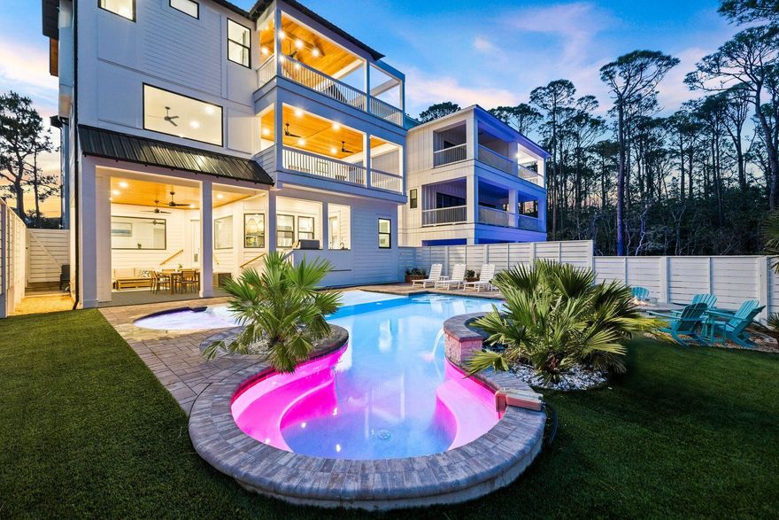 Recently built and thoughtfully designed for both luxury and performance, this exceptional Seagrove Beach retreat offers a rare combination of proven rental success--with over $300,000 of rental income on the books for 2026--elevated finishes, and resort-style amenities, all just a short stroll to one of 30A's most desirable beach accesses. Spanning over 5,400 square feet, the home features six bedrooms, each with en-suite baths, comfortably accommodating up to 26 guests. A first-floor primary suite option with a private en-suite bath adds flexibility and convenience, ideal for owners or guests seeking main-level living. Offered fully furnished and turnkey, the property boasts a proven rental history and a layout intentionally designed to maximize both guest experience and revenue. The first level opens into a bright, open-concept living and kitchen space equipped for large groups, complete with double appliances including two refrigerators, two dishwashers, double ovens, and a standalone ice maker. This space flows seamlessly to the outdoor living area, where a zero-entry lagoon-style pool, separate hot tub, outdoor kitchen, putting green, and fire pit create a private backyard setting ideal for entertaining. The second floor is centered around recreation and gathering, featuring an expansive game room with pool table, shuffleboard, poker table, and a full bar with beverage fridge. A dedicated theater room offers an immersive viewing experience, while a convenient half bath serves the main living area. Two well-appointed guest suites, each with en-suite bathrooms--one with a private balcony--complete the level, along with a covered porch overlooking the pool. On the third floor, additional guest accommodations include two king suites and a large bunk room designed to host multiple families. Offering an array of sleeping options, the bunk room has an ensuite bathroom with a triple vanity and two separate showers to fully accommodate all guests. A spacious secondary living area anchors the floor, complete with a coffee and beverage bar, and opens to a large covered deck with vaulted ceilings--an ideal setting for relaxed mornings or evening gatherings overlooking the surrounding landscape. Crowning the home, the fourth-floor rooftop deck captures sweeping Gulf views and unforgettable sunsets, offering a true vantage point rarely found this close to the beach. Distinct indoor and outdoor living areas provide ample space for guests to gather or spread out, while premium features such as a theater room, wood-clad porch ceilings, custom wall detailing in each guest suite, EV charger, and an included six-seater golf cart further enhance both lifestyle and rental appeal. Located in a non-HOA setting just steps from the Santa Clara beach access--complete with parking, restrooms, lifeguards, and a ramped walkway--this property combines convenience with one of the most sought-after stretches of coastline along 30A. Its proximity to Seaside, WaterColor, and Seagrove's dining and retail destinations, including Greenway Station, makes it an ideal choice for both investors and those seeking a high-end coastal retreat.