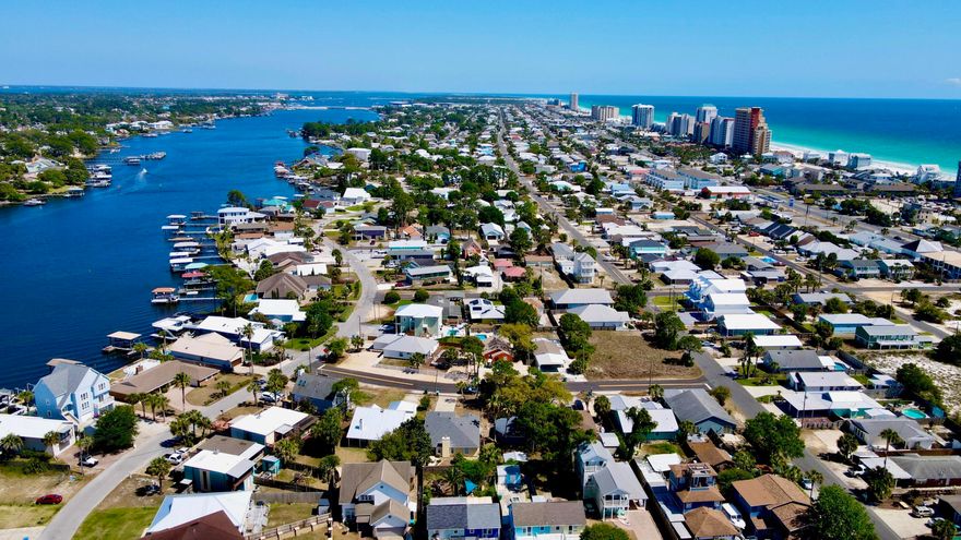 This is THE ONE you've been waiting for! The perfect beach home for an unbeatable price! What a find! This recently updated property boasts a uniquely large amount of space. With 1451 square feet, this coastal charmer has 3 bedrooms and 2 bathrooms in a split floor plan design, all on one level. Spacious indoor and outdoor living areas provide the absolute perfect accommodations for you, your family and your guests. You will love the tasteful new decor, new furnishings, and fresh paint inside and out. Mostly you will enjoy that it is all walking distance to the world's most beautiful beaches! Features include an extra large master suite with bay window, open concept living areas with vaulted ceiling, wood burning fireplace with chimney, large laundry room with full size washer and dryer, upgraded LVP flooring, owners closet, security cameras, smart thermostat, as well as new HVAC system, 2019 roof, new LG appliances, and a newly designed outdoor patio area that creates a private backyard oasis, providing ambiance with plenty of seating, space to eat, entertain, grill and relax. Next to the covered pergola, the Adirondack chairs surround the fire pit, and hammocks hang waiting in the trees. All topped off with a sprinkle of lights overhead, perfect for intimate evenings or early morning coffees. This is truly the perfect property for a forever home, vacation getaway, or investment opportunity. In addition, septic is in the front yard, so installing a pool in the back yard is an option. As an investment property, this home is rated as a ''Guest favorite'' on Airbnb based on ratings, reviews, and reliability, producing $37K in rental income in 2024, its first year as a vacation rental, and already at $20K for 2026. This seaside dream is 1/2 mile from beach access #14,#15, and #16, a 5 minute walk to Richard Selzer Park, and a short walk or golf cart ride to some of the very best restaurants and entertainment spots that PCB has to offer. Also nearby are marinas, public boat ramps, St. Andrews State Park, and more! Experience the ultimate in coastal living. This beautifully updated home is ready to enjoy! Truly turnkey, all this house is missing is you! Call today for your private viewing. *All information is approximate and should be verified by buyer if important.