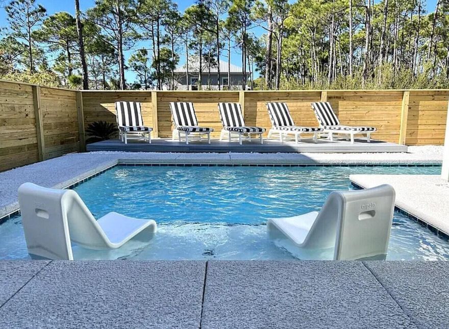 This upscale luxury beach home in Frangista Beach is one of the few properties offering space for a private backyard pool, a rare and valuable feature. Ideal for full-time living or a high performing rental investment, this gated community includes a community pool and is just a short walk or golf-cart ride to the beach and dining. Natural light fills this 4-bedroom, 4.5-bath home, designed for effortless entertaining. Each bedroom is a private suite with its own bath and walk-in closet highly desirable for vacationers. Features include 10' ceilings, upgraded wood vinyl flooring (no carpet), a large kitchen with soft close cabinetry, a massive granite island, smart home controls, oversized garage, custom blinds, and premium outdoor finishes. A must see Frangista Beach opportunity.