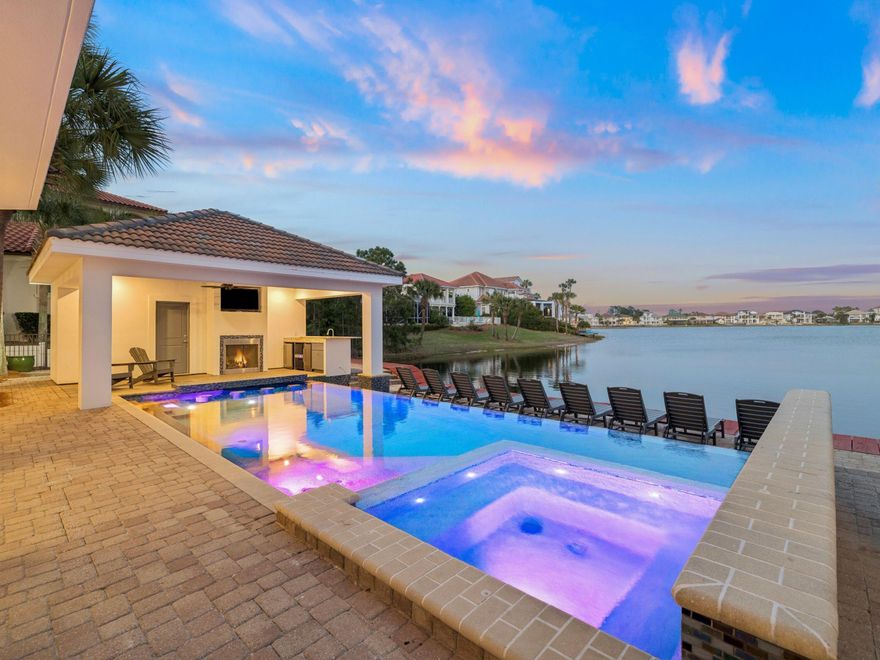 An extraordinary lakefront estate within the exclusive, gated enclave of Destiny, 4659 Destiny Way--known as The White Pearl--presents over 7,000 square feet of masterfully designed living space just moments from Gulf access and Destin's iconic sugar-white sands.

This one-of-a-kind coastal compound is composed of a grand main residence and a beautifully appointed guest house, seamlessly connected by elegant breezeways and offering a total of eleven bedrooms and ten full baths and two half baths. Each suite is designed to provide comfort, privacy, and refined coastal style--creating an exceptional setting for large-scale entertaining, multigenerational living, or luxury rental income. Set along 80 feet of pristine frontage on Four Prong Lake, the outdoor experience is nothing short of resort-caliber. An infinity-edge pool with swim-up bar and waterfall feature overlooks the water, complemented by a spa, expansive sun decks, and a fully equipped summer kitchen with gas grill--perfect for effortless entertaining. A lakeside fireplace, pool bath, and multiple gathering areas further elevate the experience, while panoramic lake and Gulf views create a breathtaking backdrop.

Inside, coastal-modern interiors are enhanced by custom finishes, multiple wet bars, wine and beverage coolers--offering seamless indoor-outdoor living and entertainment. Recent enhancements, including a refreshed exterior and updated pool systems, ensure both beauty and performance.

Designed to accommodate up to 34 guests with parking for 12 vehicles, this remarkable estate has proven itself as a premier income-producing property while maintaining the feel of a private luxury retreat. Residents enjoy access to exclusive community amenities including tennis courts, a fitness center, and a golf cart-friendly lifestyle--all within one of Destin's most coveted communities.

Whether envisioned as a legacy family compound or a high-performing investment, The White Pearl embodies the scale, sophistication, and resort-style living that define the Emerald Coast's finest properties.