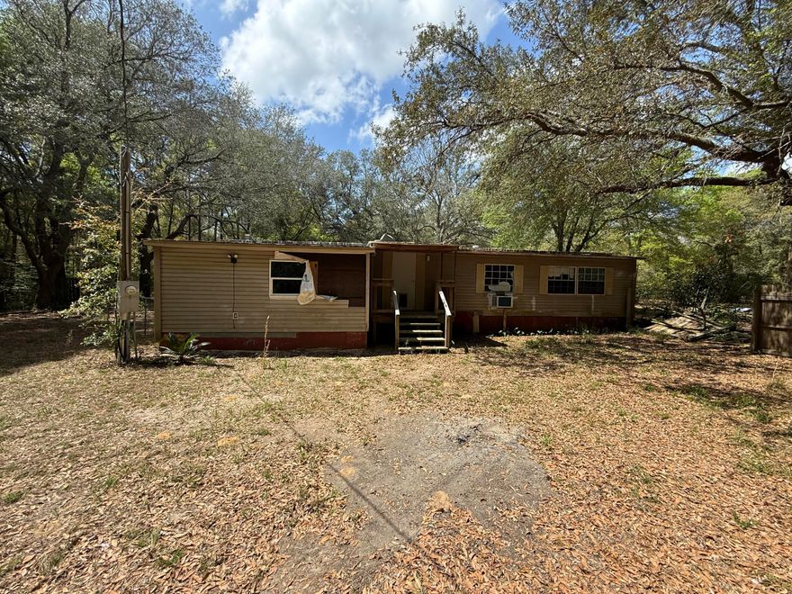 Investor special! This 3-bedroom, 2-bath mobile home sits on a full 1-acre lot in Holt, offering plenty of potential for the right buyer. Featuring approximately 1,250 sq ft and conveniently located near I-10 for easy access to Crestview and surrounding areas. Property includes a shop/apartment combo equipped with electric and water, a kitchenette, and full bathroom--ideal for additional living space, rental potential, or workspace. Home is in need of repairs and updates--bring your vision and make it your own. Being sold strictly as-is, seller makes no warranties, expressed or implied. Great opportunity for investors, flippers, or those looking for a project with land!