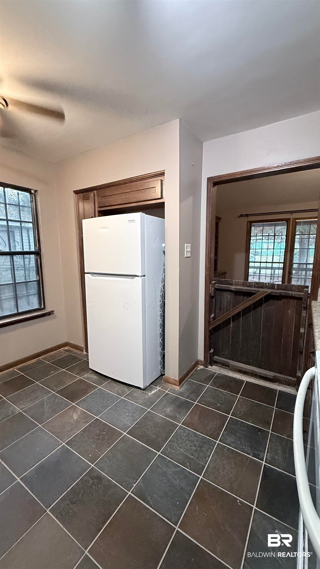 Kitchen with plenty of natural light and freestanding refrigerator