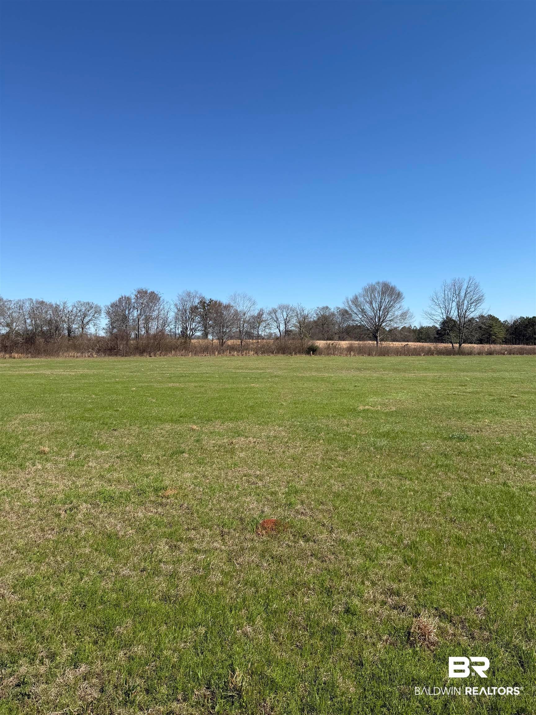 View of green lawn with a view of countryside