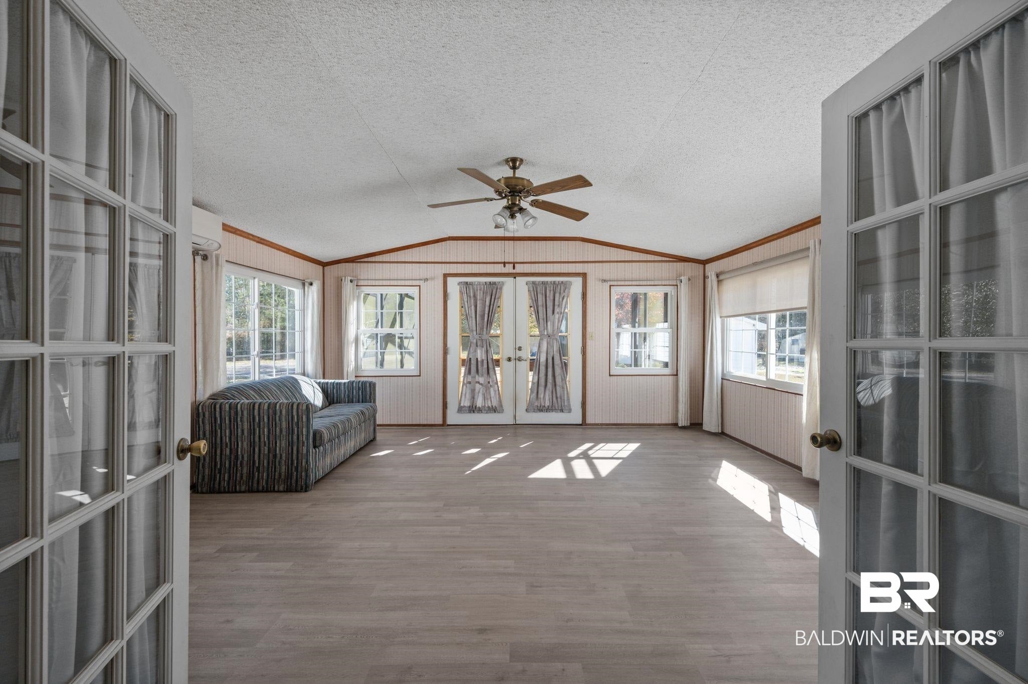 Sunroom / solarium with french doors and vaulted ceiling