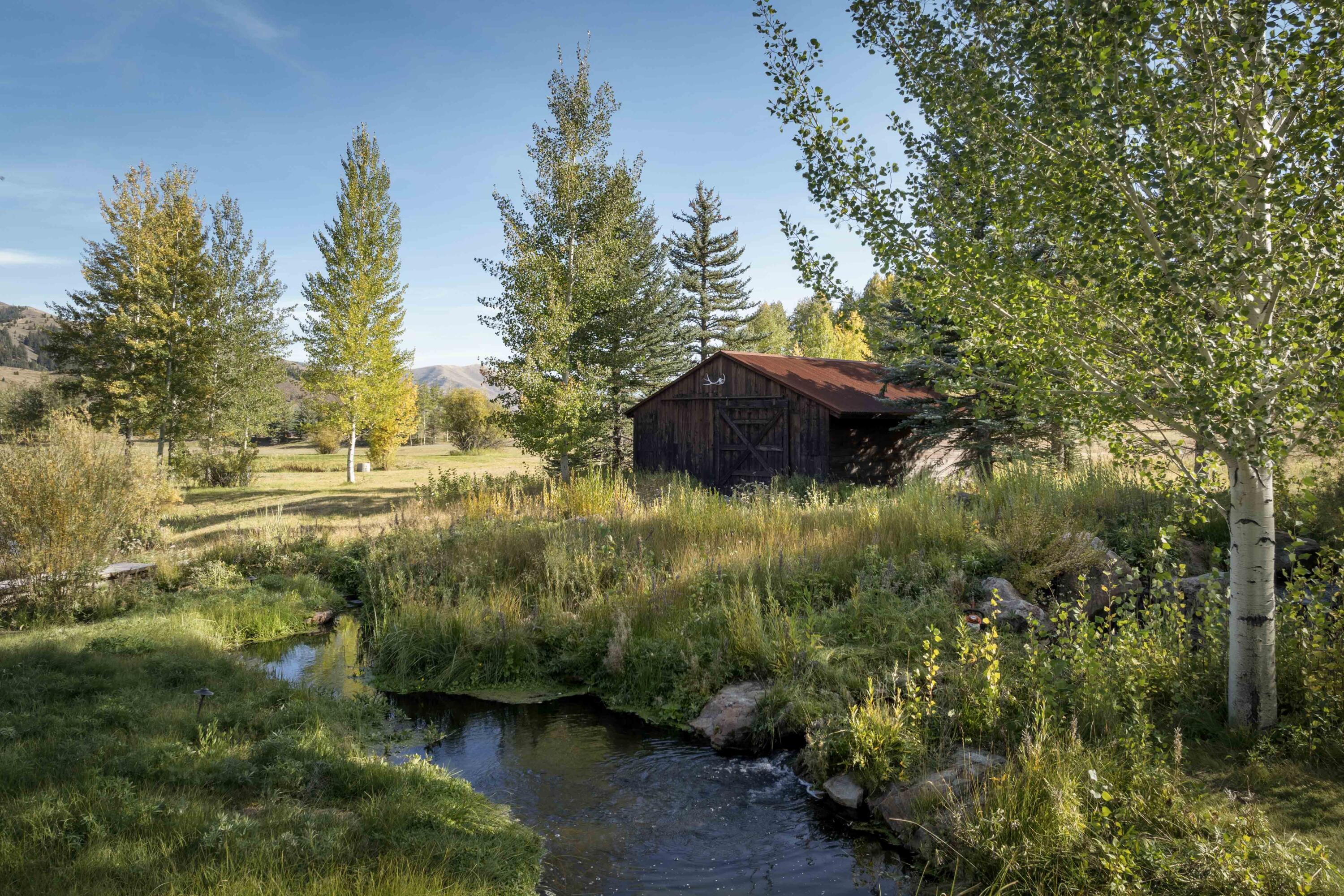 Water feature with storage barn