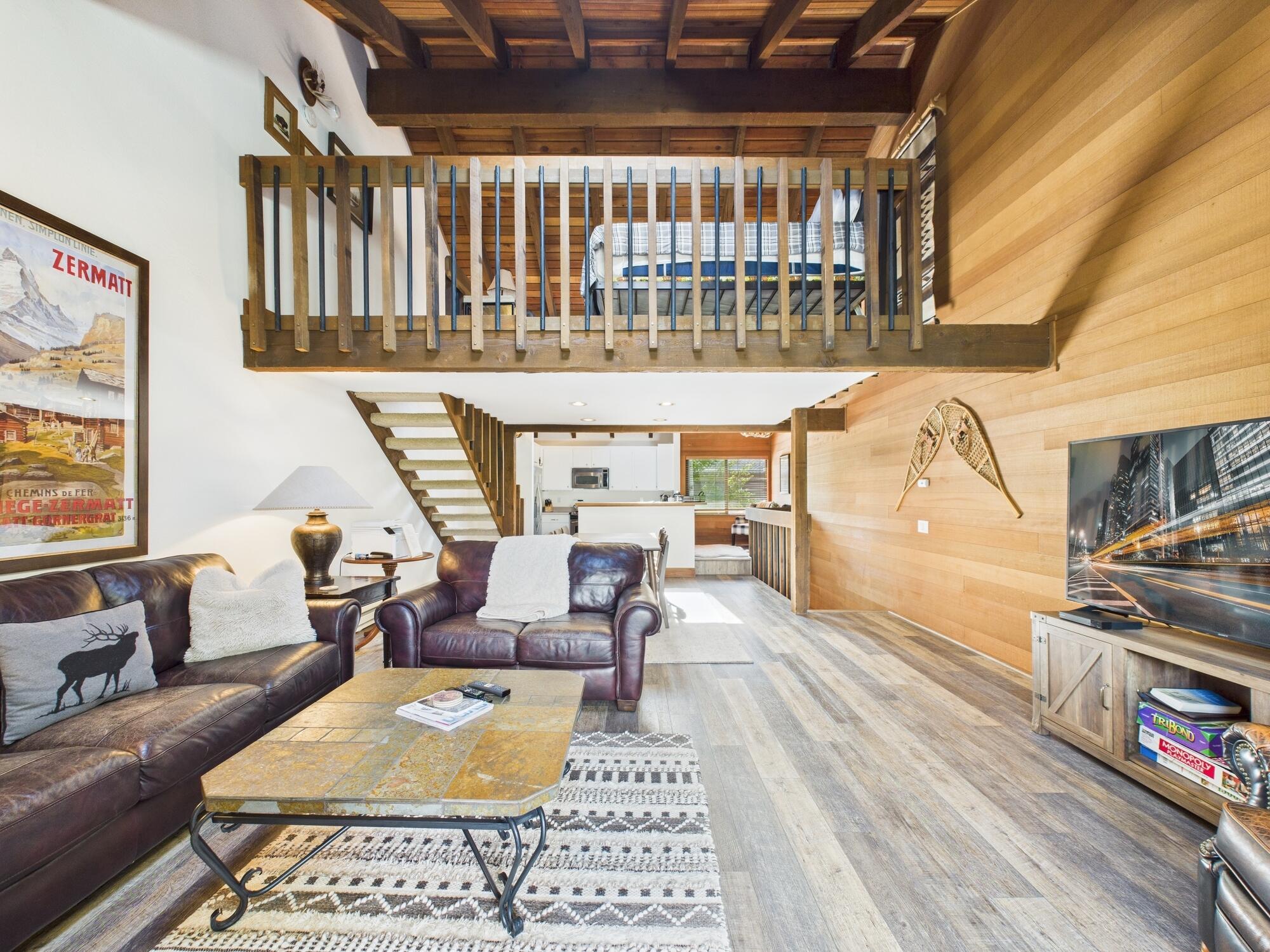 Living room with view of loft area