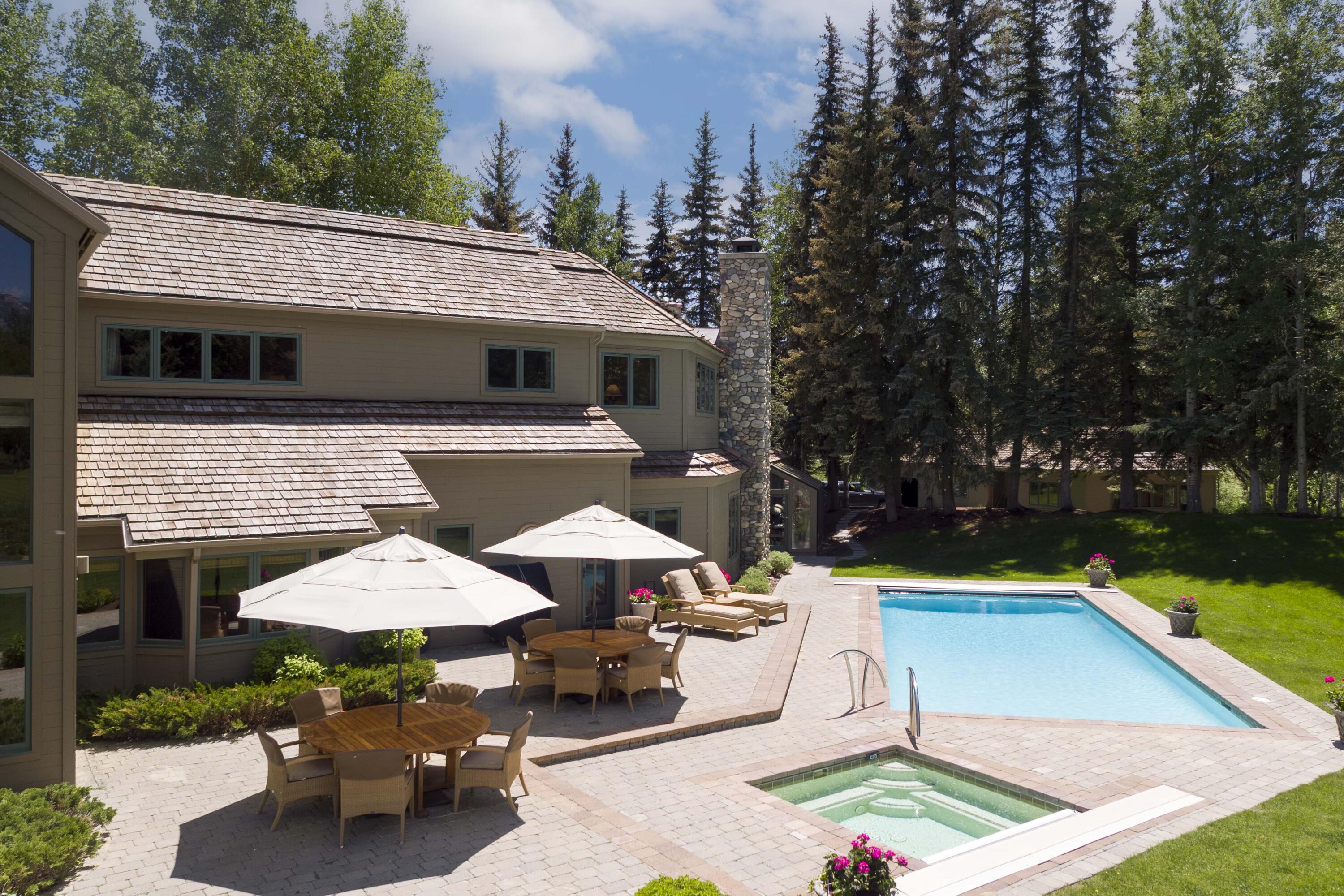 Patio with hot tub and pool