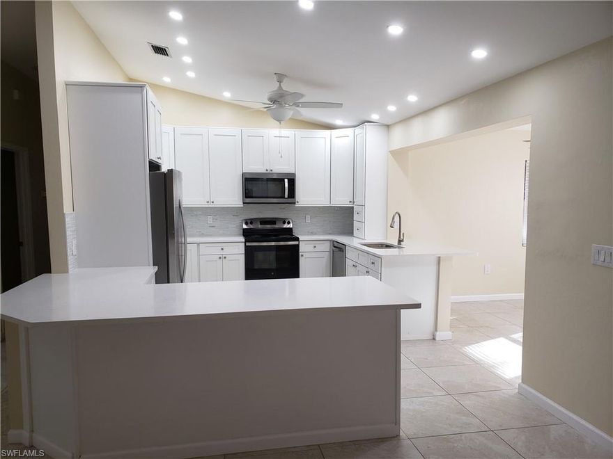 This San Carlos Park home is available for annual lease. Tucked away on a quiet street , it offers privacy, no HOA, and peace of mind. The 3-bedroom, 2-bath split floor plan sits on an oversized lot and features new tile floors, impact windows, full-opening sliders, for a bright, open feel. The upgraded kitchen flows seamlessly into the living space and includes quartz countertops with full backsplash, soft-close cabinetry, stainless steel appliances, and a breakfast bar. There is pantry storage between garage and living area, The primary suite offers a walk-in closet and a beautifully updated bath with a tiled walk-in shower and quartz vanity.