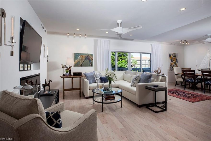 Sweet dreams are made of this lovely renovated waterfront condo in Old Naples. Soft hues and neutral finishes are the perfect backdrop for comfortable, easy living. Significant renovations have been made to maximize efficiency and add luxurious finishes throughout. Rooms are generous in size and offer abundant storage. Entertaining is easy with the built-in bar and beverage cooler. Built in display cases are the perfect place for sharing your favored treasures. A backsplash of crisp white tiles, beige/grey quartz counters, white cabinets with soft close features and pantry frame the handsome kitchen. Light and bright bathrooms are delightful complements to the space. A reflective ceiling, 8-foot doors, plantation shutters, roll down shades, electric fireplace, decorative art lights, wood floors, carpeted bedrooms and in-residence washer/dryer are just a few of the features in this exceptional property. Location, location, location abound! Walk to the well-known shops and restaurants of Old Naples. Travel by car, or travel by boat to enjoy this special home. On-site boat docks are available for lease.