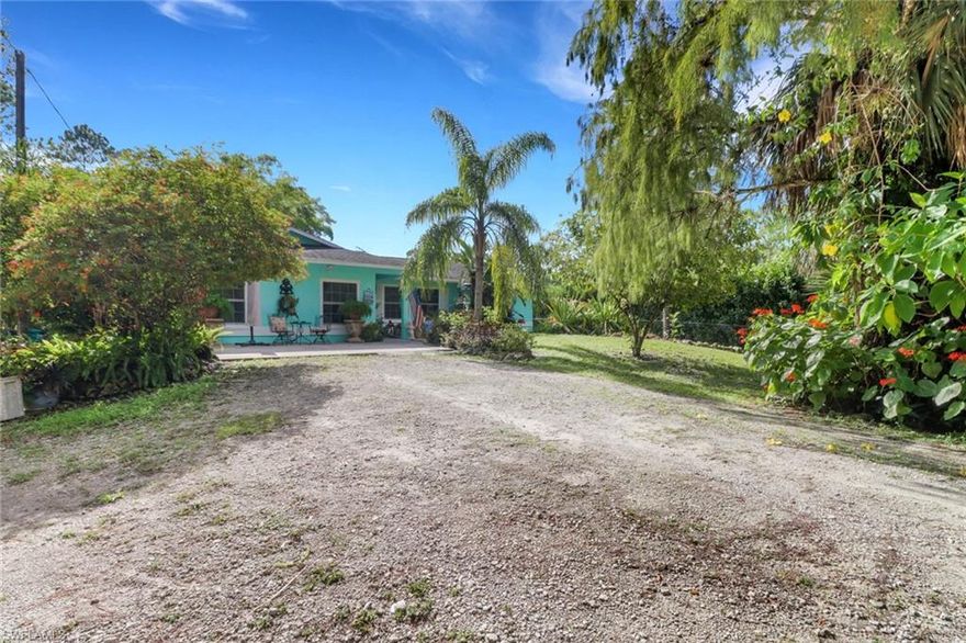 A tropical Naples hideaway on 1.14 acres—with the rare opportunity to purchase the adjacent 1.14-acre lot as well, giving you a total of 2.28 acres—this Golden Gate Estates property blends privacy, charm, and exceptional value. This inviting 3 bedroom + den, 2 bathroom home features a desirable split floor plan and sun-filled living spaces full of character, colorful designer touches, and serene views of the lush greenery surrounding the home. A NEW roof is coming soon, and the property is equipped with NEW gutters and downspouts for added peace of mind. This home is an incredible energy-efficient find, as the entire house runs on solar power, including a solar attic fan and a solar-assisted water heater (water heater is both electric and solar), resulting in remarkably low electric bills. The solar panels have also been professionally serviced and cleaned, offering optimal performance for years to come. Inside, the kitchen features wraparound tile counters, a breakfast bar with bright café-style seating, and a comfortable flow into the dining and living areas. Outdoors, the property transforms into a private tropical oasis with mature bamboo, palms, and vibrant plantings creating natural privacy. A shaded paver patio is perfect for gatherings, and the expansive backyard provides ample storage, room for recreational toys, and space to add a large resort-style pool. With no HOA restrictions, this home is ideal for investors, seasonal residents, or full-time buyers seeking quiet country living close to town. The option to acquire the adjacent vacant parcel enhances the potential to create a family compound, build an additional residence, or simply enjoy the added privacy and land. This is a truly unique opportunity to own an energy-efficient, estate-style property with room to grow.