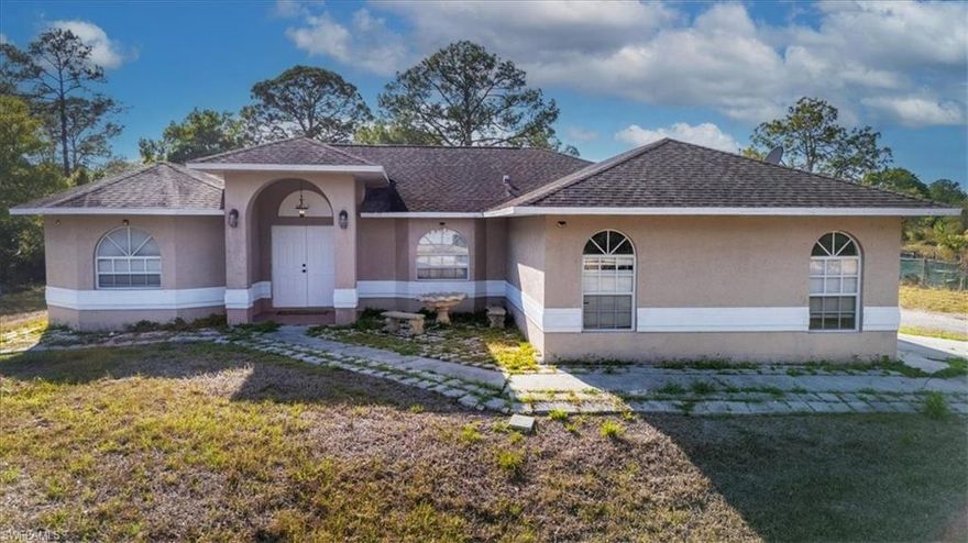 Motivated sellers! Experience the space, privacy, and freedom of country style living in this beautifully maintained 3 bedroom, 2 bath home set on 1.25 acres in sunny Southwest Florida. Offering 1,739 sq ft of comfortable living space, the home features a desirable great room layout and a dedicated dining area that is ideal for both everyday living and entertaining. The long driveway, expansive front yard, and oversized backyard provide endless possibilities. Whether you are dreaming of adding a barn, pool, workshop, or simply enjoying the extra room to roam, this property offers the flexibility to make it your own. With wide side access on both sides of the home, there is ample space to park boats, RVs, and other recreational vehicles with ease. The spacious owner’s suite serves as a private retreat, featuring a large walk in closet and a luxurious ensuite bath complete with porcelain tile floors, a dual sink vanity, walk in shower, and a soaking tub. Recent upgrades include a new 20 gallon water pressure tank and a whole home water filtration system, adding convenience and peace of mind.