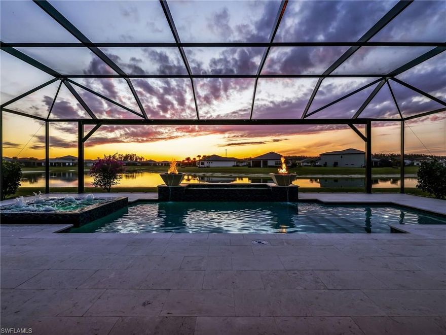 WOW WOW WOW This highly anticipated estate home is finally here. This impressive estate residence offers 4,411 square feet under air and features more than 550,000 in custom upgrades, delivering a level of craftsmanship, scale, and luxury rarely found in today’s homes. Set on a peaceful water lot with sunset views, the home was designed for both elegant everyday living and exceptional entertaining. From the moment you enter, wide open hallways and dramatic sightlines draw you through the home toward the stunning custom pool and spa with fire bowls, creating an immediate sense of arrival. Soaring ceilings on both levels, designer lighting, and custom woodwork throughout enhance the refined yet welcoming atmosphere, ideal for both intimate gatherings and larger celebrations. The thoughtfully designed floor plan emphasizes en suite living, offering privacy and flexibility throughout. Two en suite guest bedrooms are located on the main level, well suited for visitors or multigenerational living. Upstairs, there are two additional en suite bedrooms along with two more bedrooms connected by a Jack and Jill bath, allowing every space to function comfortably and with purpose. The chefs kitchen is a true focal point of the home, featuring custom built in appliances, an oversized island, premium cabinetry, and extensive specialized storage. Additional features include custom pantry cabinetry, a coffee bar, an entertainment and butlers pantry, and a custom wine cave, all designed to support effortless hosting. The owners suite serves as a private retreat with French doors leading to a sitting room, an expansive bedroom with sweeping water views, and a spa inspired bath. The bathroom offers two walk in closets, a private water closet, separate sinks and vanities, a sauna, and a custom shower. Outdoor living is equally impressive. The custom pool and spa are set within the largest lanai in the community and enclosed by a 30 foot screen cage, significantly higher than standard, creating an expansive and resort style outdoor living space. Additional features include a three car garage with epoxy floors, quality hurricane rated construction, and thoughtful finishes throughout the home. This exceptional property is located within a premier resort style community offering an unmatched lifestyle. Amenities include indoor and outdoor pickleball and tennis, a state of the art fitness center, a resort pool and adult spa, indoor and outdoor dining with a pool bar, a craft lounge and sports bar, café and marketplace with ice cream, indoor basketball, a racquet pro shop, movement studio and yoga lawn, bocce ball, private party room, playground, dog park, and sidewalks and streetlights throughout, resort-style pool, fitness center, indoor and outdoor sports courts, and an on-site restaurant. Ideally located close to Gulf Coast Town Center, RSW Airport, and the beaches of Bonita Springs and Naples. Some photos are digitally staged