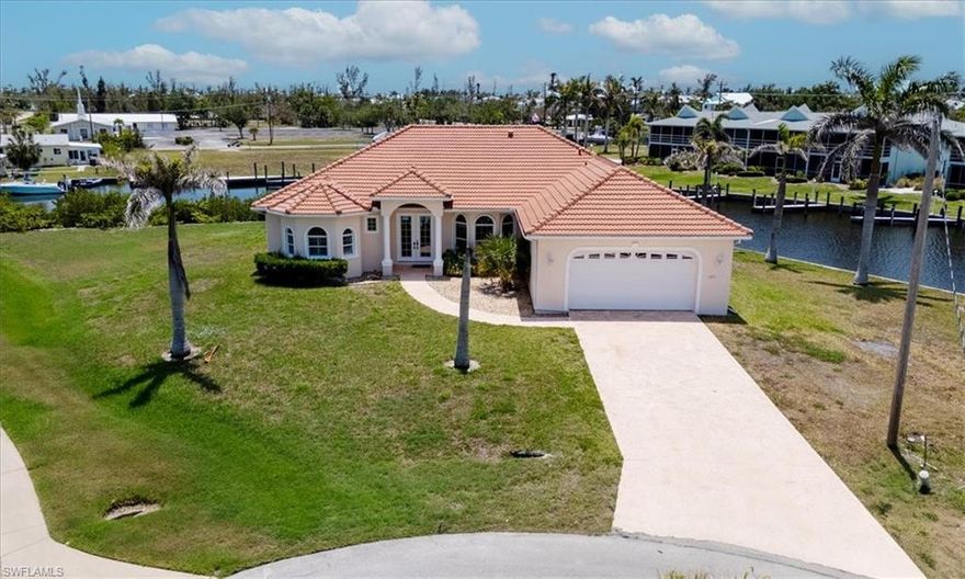 Luxury living at its finest.  Don't miss this opportunity to own this stunning home on Pine Island in St. James City.  The home is situated on a waterfront oversized lot on a Cal-du-sac with 294 feet of water frontage on the Dawson Canal just a short boat ride to Matlacha Pass, the Caloosahatchee River, Pine Island Sound and the Gulf of Mexico.  The boating and fishing options are endless. The home features open concept living with high ceilings and a split plan, ideal for guests and entertaining. The living room opens up to a large, screened pool deck area and a heated pool.  The large master bedroom has his and hers walk in closets, a large walk-in shower and an elevated jacuzzi tub.  The home has tile throughout, is tastefully decorated, and comes fully furnished.  It is constructed to high standards featuring an elevated house pad, and concrete block construction.