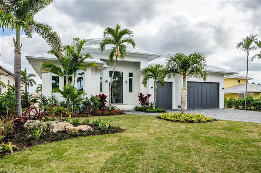 Introducing a stunning new waterfront home in Royal Harbor.  Custom built by Greenwald Builders, one of Naples luxury home builders.  This coastal inspired home offers the convenience of main level living.  Featuring a great room floor plan, four bedrooms each with an en-suite bathroom.  Enjoy the Florida lifestyle with an elegant outdoor living area including a well appointed outdoor kitchen, gas heated pool/spa, outdoor shower, pool bath, electric screens and shutters.  Luxury finishes include a cupola that offers maximum advantage of natural light, wide plank wood floors, marble tile in master bath.  Other features include Viking appliances with 48" professional gas cooktop.  Situated on a canal with a new seawall and dock, Boaters will appreciate the quick no bridge access to Naples Bay and the Gulf of Mexico.  Only minutes from Fifth Avenue South, beaches, shopping and dining.