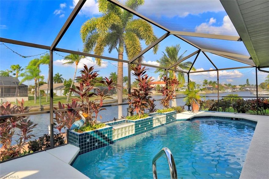 Direct gulf access pool home located in sought after SW location close to Cape Harbour with 3 graciously sized bedrooms, 2.5 bathrooms and 2 stall garage located on the Traveler Canal. Exotic wood flooring throughout the main living area and bedrooms with Italian tile in kitchen, laundry room and bathrooms. Crown molding can also be found in most rooms. The updated kitchen hosts granite counter tops with wood cabinetry, tile backsplash and has a breakfast nook with built-in serving area. There's also a formal dining room for those more formal occasions. The master is large enough to house a king bedroom set with a ensuite with dual sinks, custom mirrors, granite counter tops and walk-in shower with access to pool area. Open the pocket sliders along the back of the home and invite the inside out! There's covered space to entertain by the pool while enjoying the water views as you're just located a home away from intersecting expansive canal views. Boating couldn't be easier with your own boat lift with Captain's walk right out the back door with direct gulf access.  Plenty of parking with circular driveway! Close proximity to Publix, shopping and fine dining.  Call today to see!