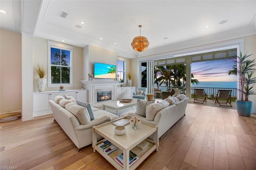 Beautifully renovated, coastal contemporary DIRECT BEACHFRONT home with panoramic Gulf of Mexico views. This light & airy beachy retreat feels like a new construction home, with elevator, a fantastic open floor plan including crisp white/blue gourmet chef’s kitchen, great room with new 10 ft pocketing sliders opening to the beachfront veranda & an expansive master suite with sitting areas, private balcony & renovated spa-like bath. Delight in the year-round Gulf sunsets & sound of surf from one of multiple balconies or the spacious pool deck with stone floors, outdoor kitchen & rare lush lawn perfect for pets or outdoor activities with the beach beyond.  Recent renovations include impact glass sliders, oak wide plank flooring, quartz counters in the stunning kitchen, gas fireplace with wood paneling & quartz inlay, LED lighting & designer light fixtures, interior & exterior surround sound system, new exterior paint/railings & more.  Perfectly located minutes to Mercato & North Naples’ amenities, this state-of-the-art beachfront masterpiece boasts only the finest features, finishes & décor, with the Gulf of Mexico as the backdrop.