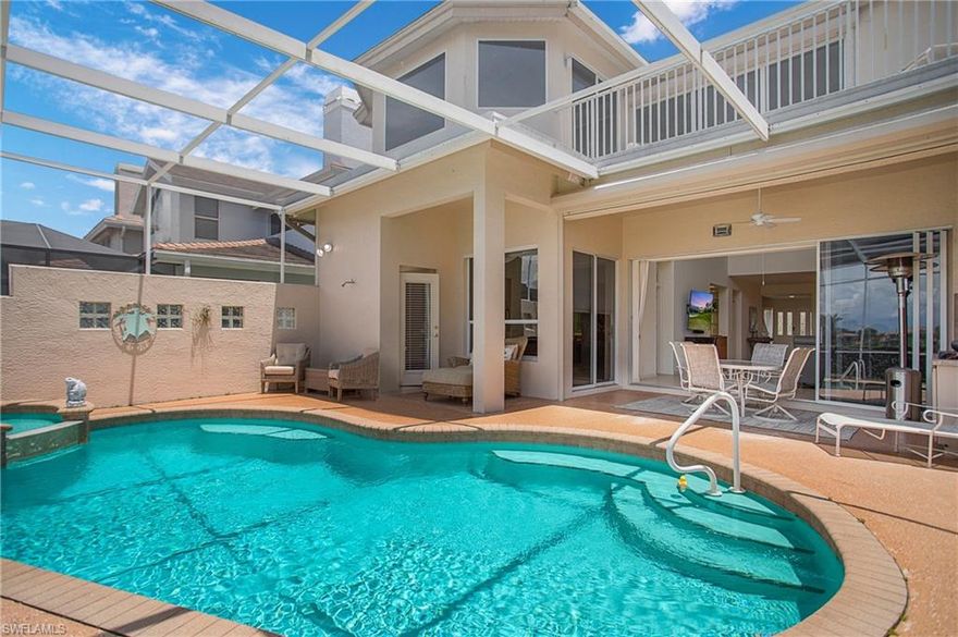 You won't want to miss this rarely available expansive home with picturesque golf course and lake views in highly sought-after Ana's Place at The Strand! This desirable North Naples location is just a short 6 miles to white-sand beaches. This light-filled 2-story home features over 4500 square feet of indoor and outdoor living space, 4 bedrooms plus a den and loft, and 3 full and 2 half bathrooms. You'll love the soaring volume ceilings, open layout, and elegant finishes such as a working fireplace, and stainless-steel appliances. This home also offers the flexibility of using the first floor bedroom with lanai access as the owner's suite, or the upstairs bedroom with a bay windows and private balcony.  Take in beautiful sunset views overlooking the golf course and lake while sipping cocktails on your private screened lanai. A large heated pool, integrated spa, outdoor shower and ample dining, entertaining, and outdoor living space complete the outdoor oasis. Enjoy the current social membership or upgrade to a sport or golf membership. Amenities include a clubhouse, 2 restaurants, golf course, community pool, tennis, pickleball, basketball, bocce ball, walking/jogging paths and so much more!  With so much to offer just outside your doorstep, including world class dining, shopping, entertainment, along with easy access to I-75 and US-41, this home truly has it all!