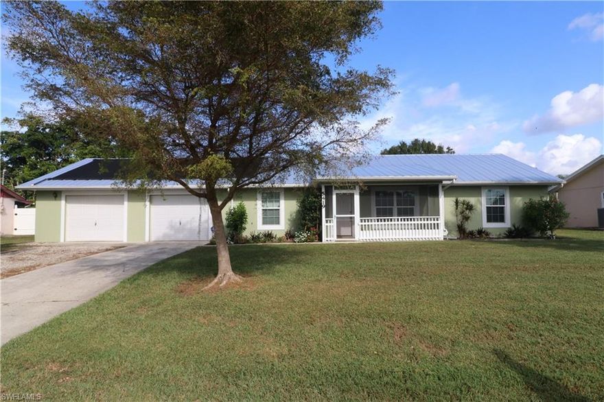 Great value for this spacious 3 bedroom 2 bath home with large heated pool and separate spa.. huge 2 car garage with overhead doors, perfect for a workshop or boat storage. This home offers all tile flooring throughout, new 1 year old  metal roof,  oversized fenced in yard, large lanai, impact windows and doors in 2012, and beautifully updated kitchen with wood cabinetry and granite countertops. fabulous quiet location.